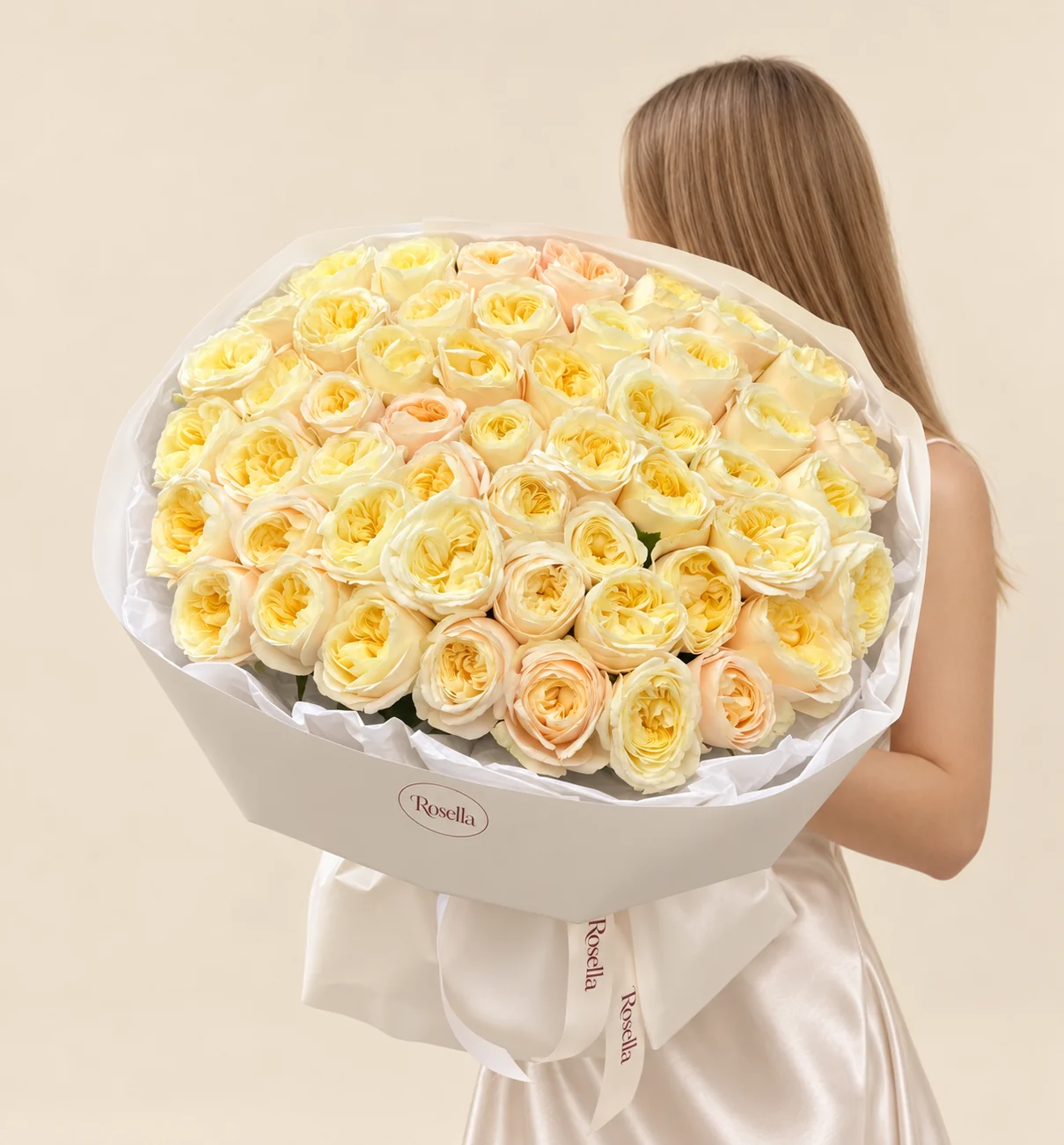 56 cream garden roses & 5 peach garden roses in a hand-tied bouquet