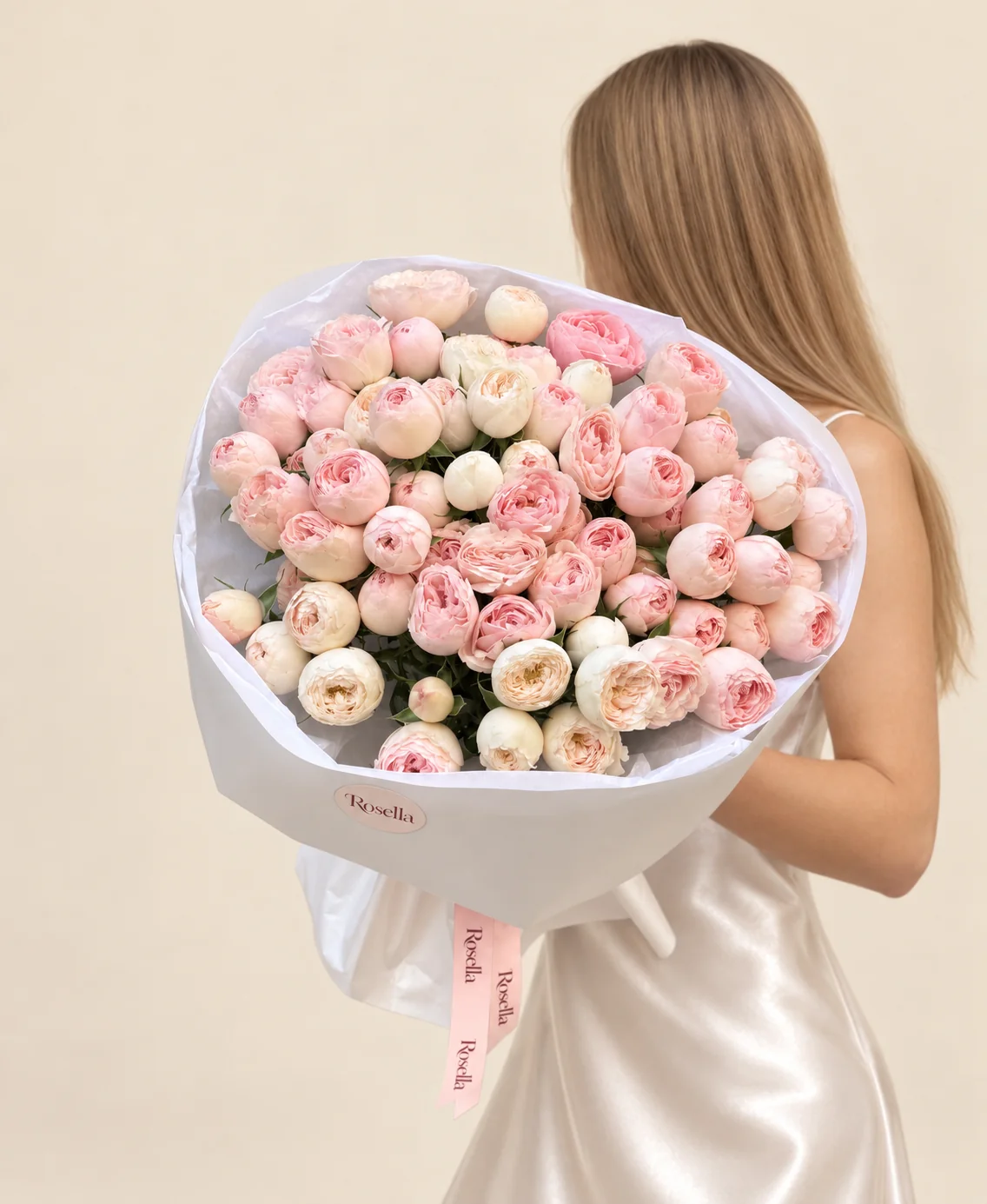 56 blush spray roses & 20 cream spray roses in a hand-tied bouquet