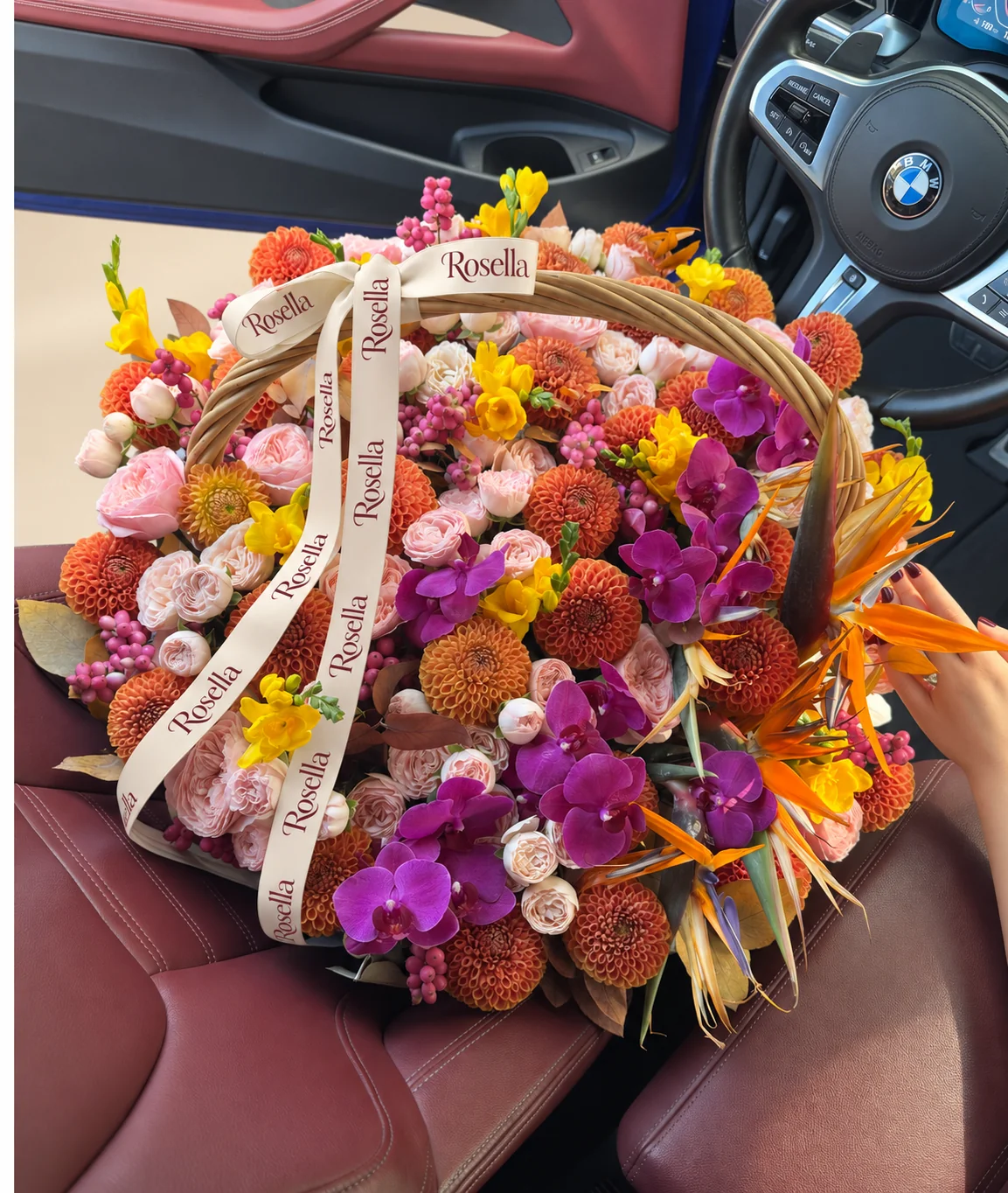 34 dahlias, 11 garden roses, 7 orange and blue bird of paradise (strelitzia), 16 orchid blooms, 25 cream spray roses, 21 blush spray roses & 7 freesias in a basket
