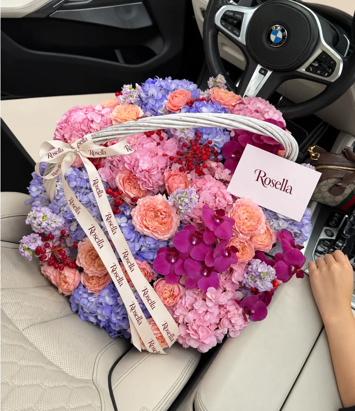 22 garden roses, 9 blue hydrangeas, 9 pink hydrangeas, 15 orchid blooms & 6 stocks in a basket