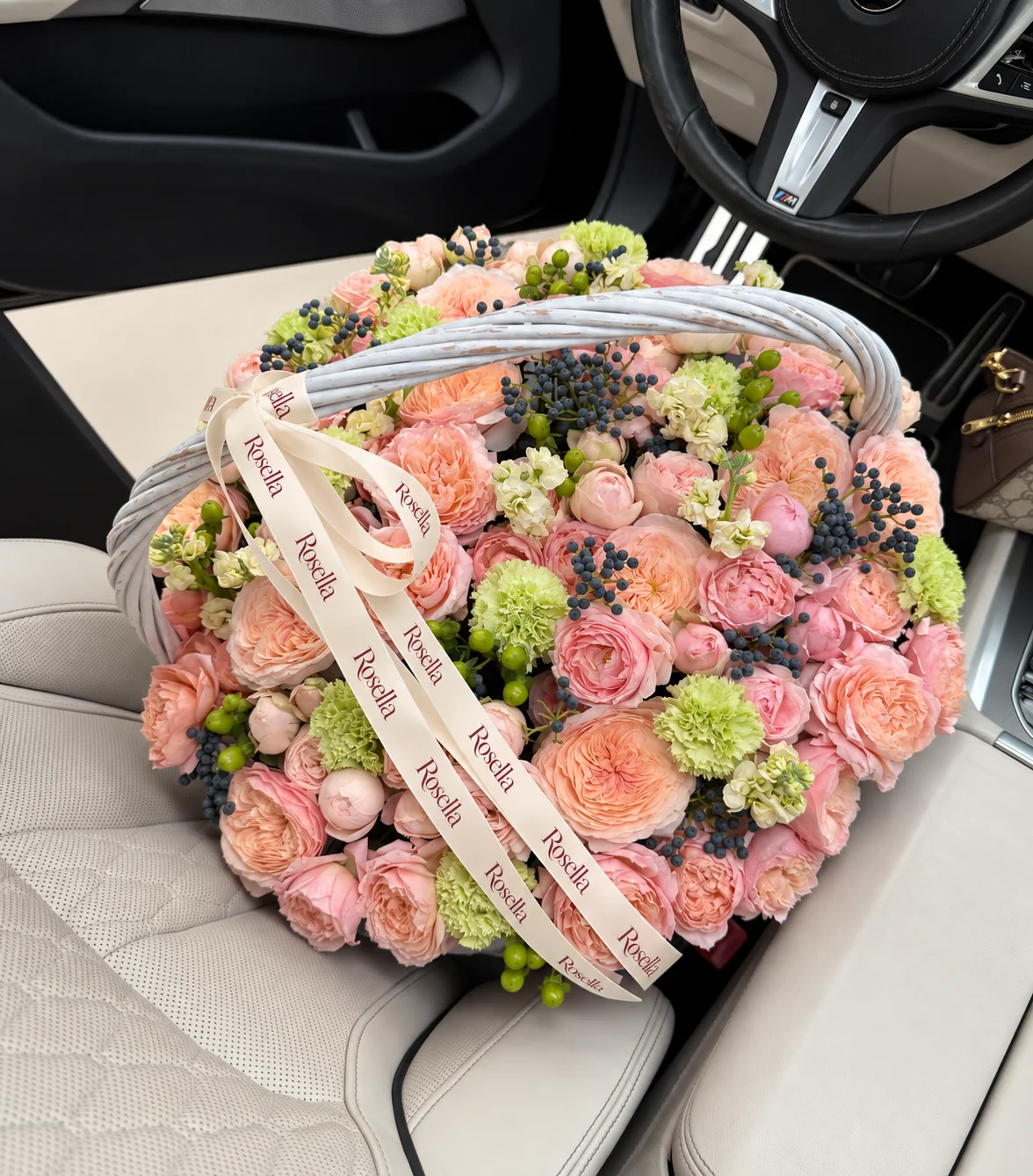 27 peach garden roses, 15 blush garden roses, 24 spray roses, 5 stocks & 12 carnations in a basket