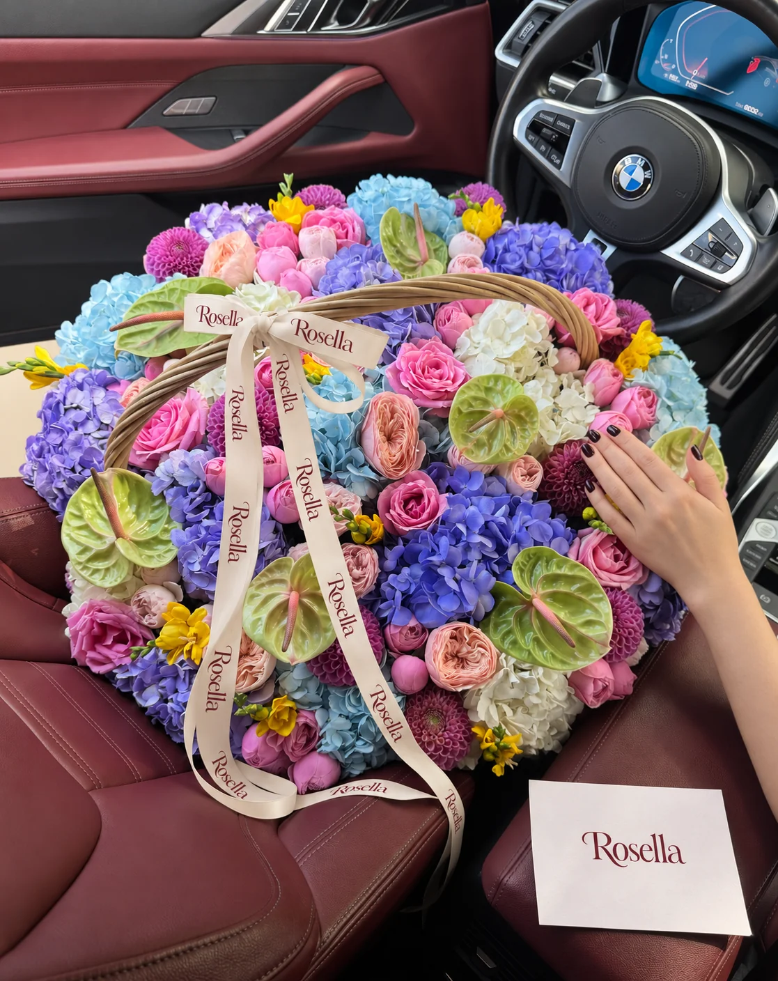 12 lavender hydrangeas, 7 blue hydrangeas, 7 cream hydrangeas, 11 dahlias, 10 garden roses, 15 roses, 25 pink spray roses, 7 anthuriums, 8 freesias & 7 cream spray roses in a basket