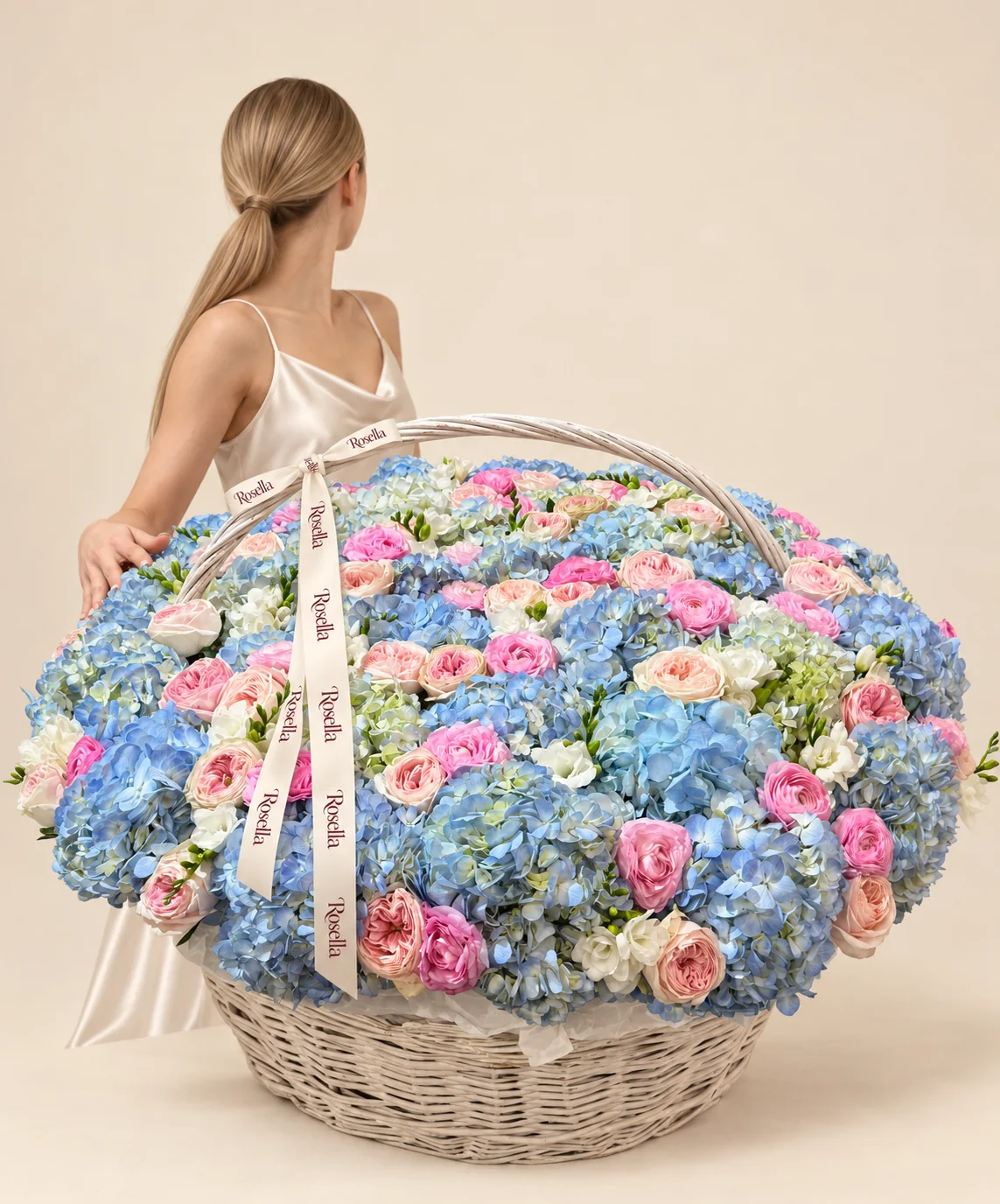 35 blue hydrangeas, 35 cream garden roses, 4 white hydrangeas, 9 pink garden roses, 14 ranunculus, 14 freesias & 5 roses in a basket