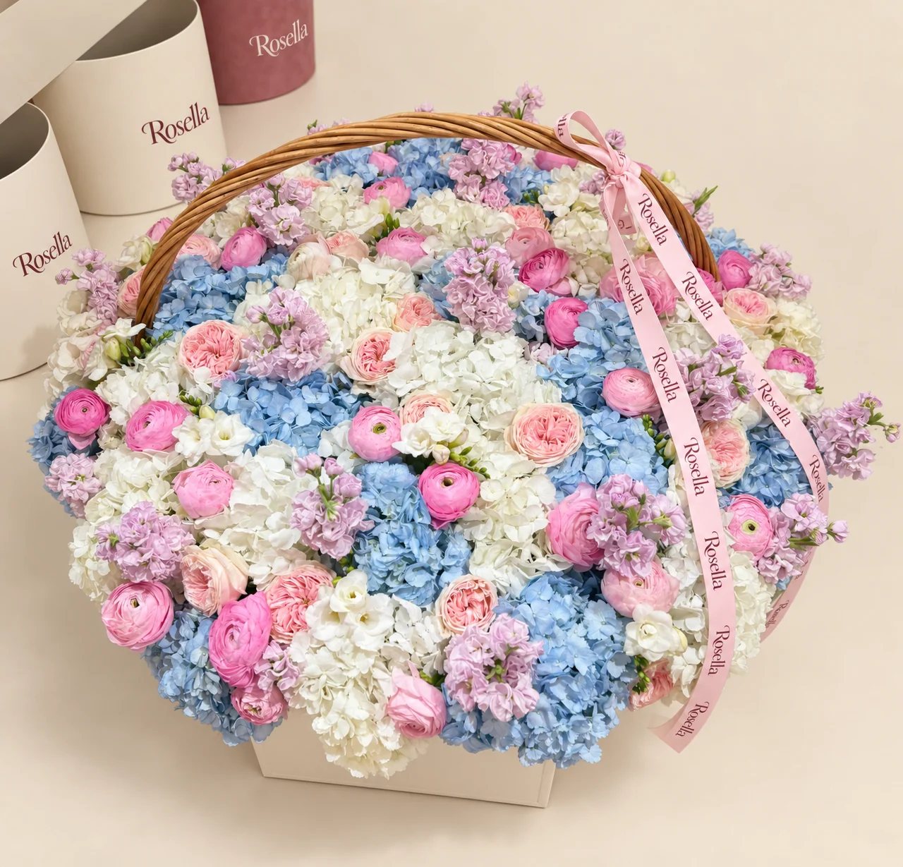 24 blue hydrangeas, 21 white hydrangeas, 20 garden roses, 30 ranunculus, 14 stocks & 45 lisianthus blooms in a basket