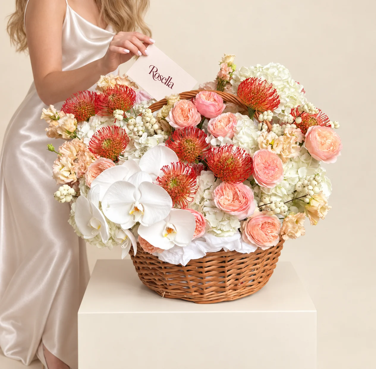 9 hydrangeas, 12 garden roses, 9 red-orange leucospermum (pincushion protea), 26 lisianthus blooms & 7 orchid blooms in a basket