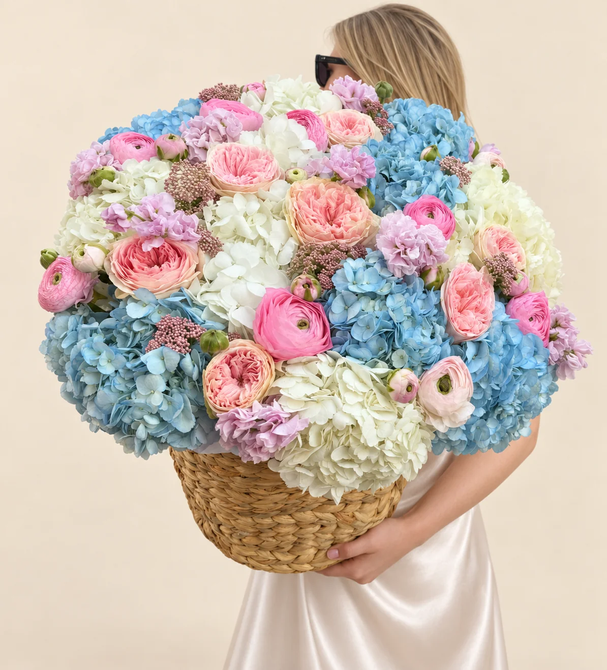 9 blue hydrangeas, 9 white hydrangeas, 9 garden roses, 14 pink ranunculus, 4 stocks & 5 blush ranunculus in a basket