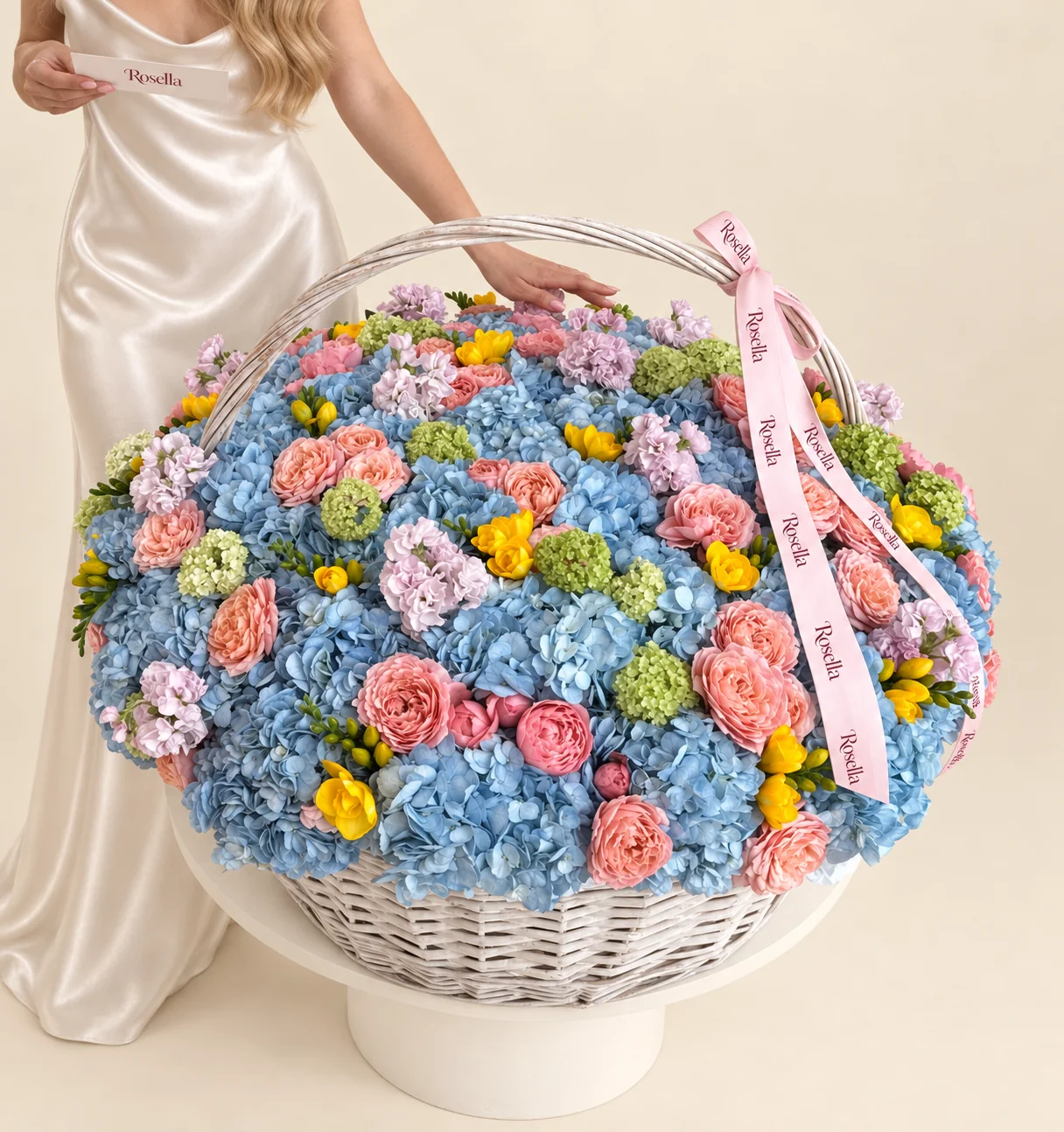 45 hydrangeas, 36 peach garden roses, 16 green snowball viburnum, 11 pink garden roses, 9 stocks & 11 freesias in a basket
