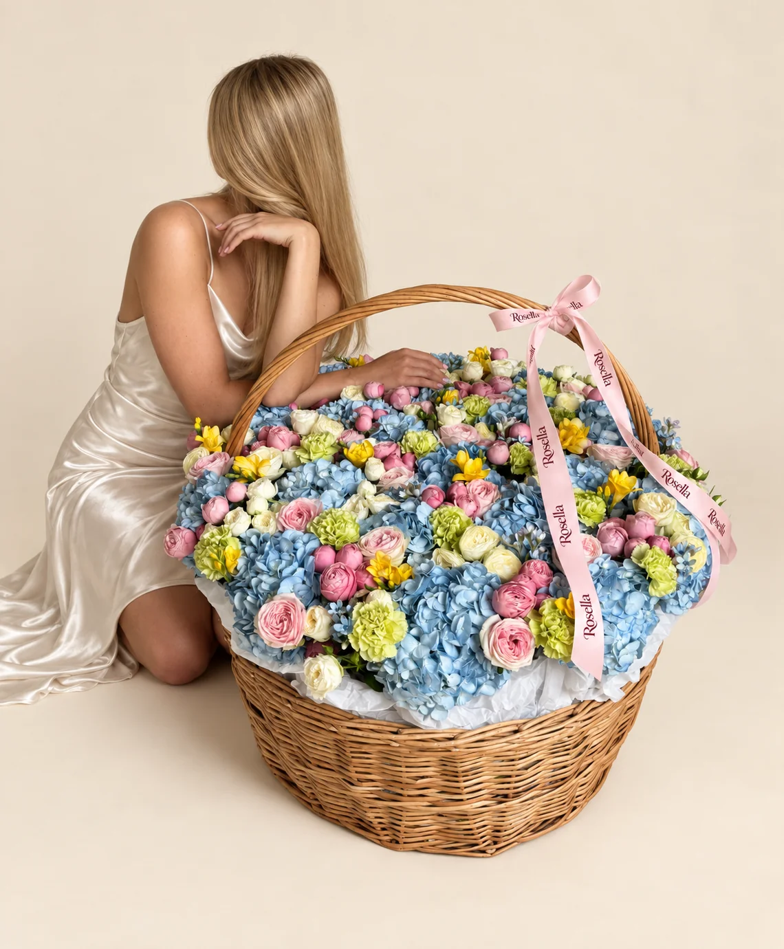 23 hydrangeas, 14 garden roses, 48 pink spray roses, 37 ivory spray roses, 18 carnations & 9 freesias in a basket