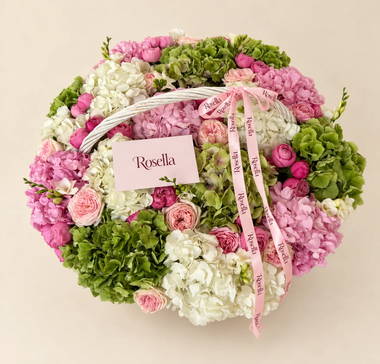 7 green hydrangeas, 7 white hydrangeas, 6 pink hydrangeas, 11 garden roses, 27 spray roses & 6 freesias in a basket