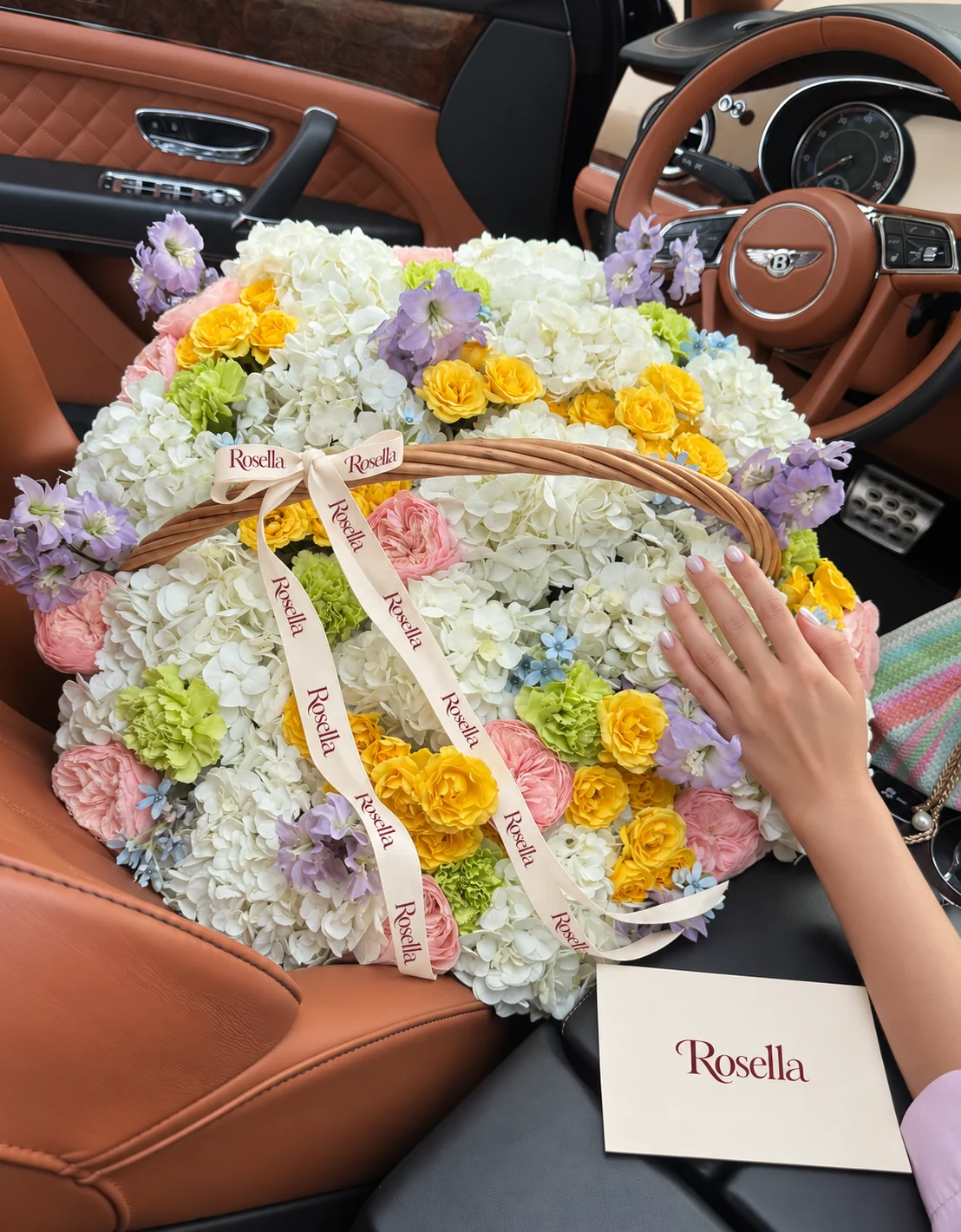 18 hydrangeas, 14 garden roses, 43 spray roses, 3 delphiniums, 11 carnations & 27 tweedia blooms in a basket