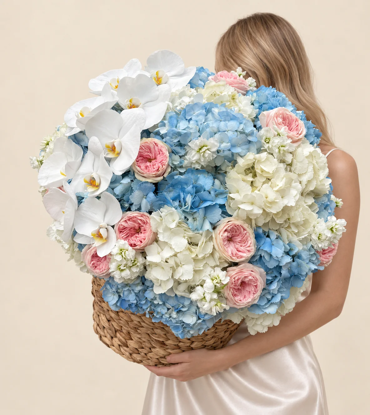 10 blue hydrangeas, 6 white hydrangeas, 12 garden roses, 10 orchid blooms & 3 stocks in a basket