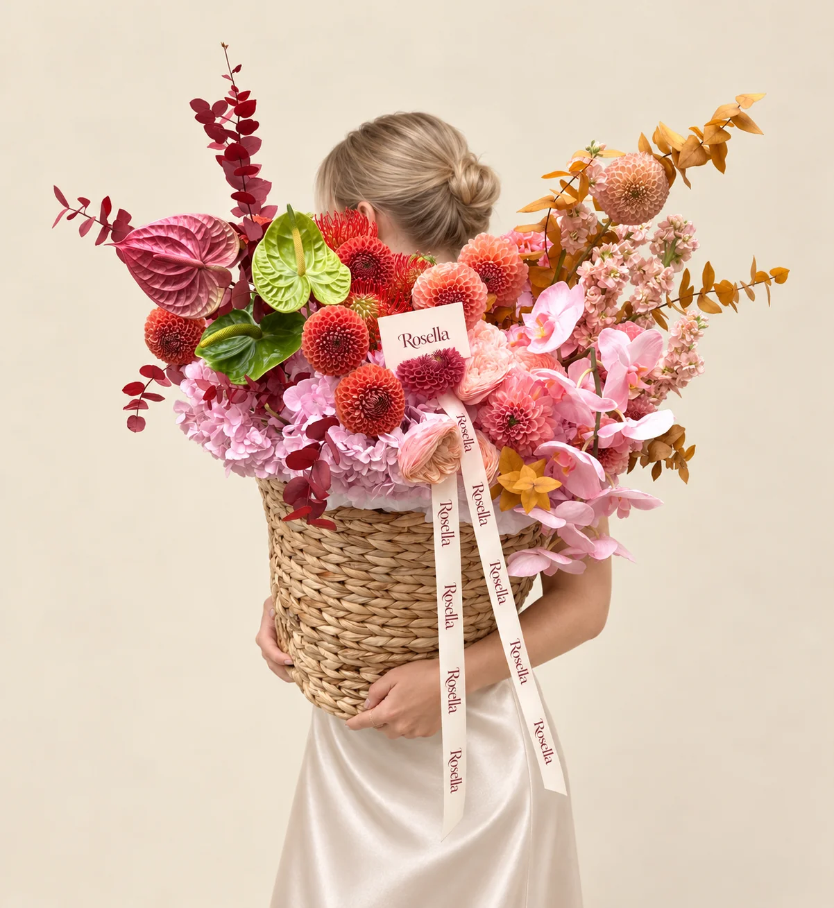 4 hydrangeas, 12 orchid blooms, 5 coral dahlias, 5 peach dahlias, 4 pink dahlias, 3 red leucospermum (pincushion protea), 3 stocks, 5 ranunculus, 2 green anthuriums & 1 burgundy anthurium in a basket