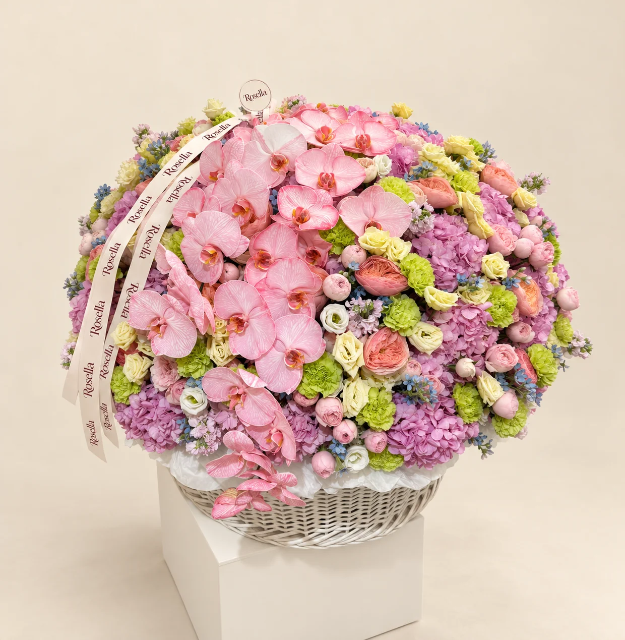 21 hydrangeas, 28 orchid blooms, 28 carnations, 10 garden roses, 32 spray roses, 36 yellow lisianthus blooms, 80 tweedia blooms, 6 stocks & 8 white lisianthus blooms in a basket