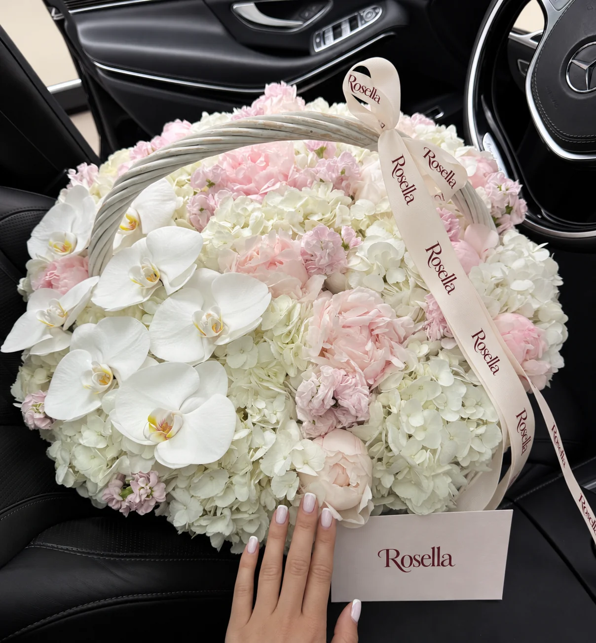 11 hydrangeas, 12 blush peonies, 5 stocks, 7 orchid blooms & 1 ivory peony in a basket