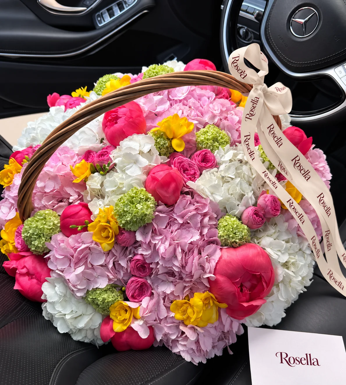 9 pink hydrangeas, 12 peonies, 6 white hydrangeas, 19 spray roses & 7 freesias in a basket