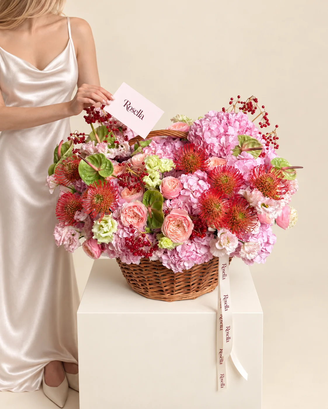 10 hydrangeas, 10 red-orange leucospermum (pincushion protea), 12 garden roses, 21 blush lisianthus blooms, 6 anthuriums & 9 green lisianthus blooms in a basket