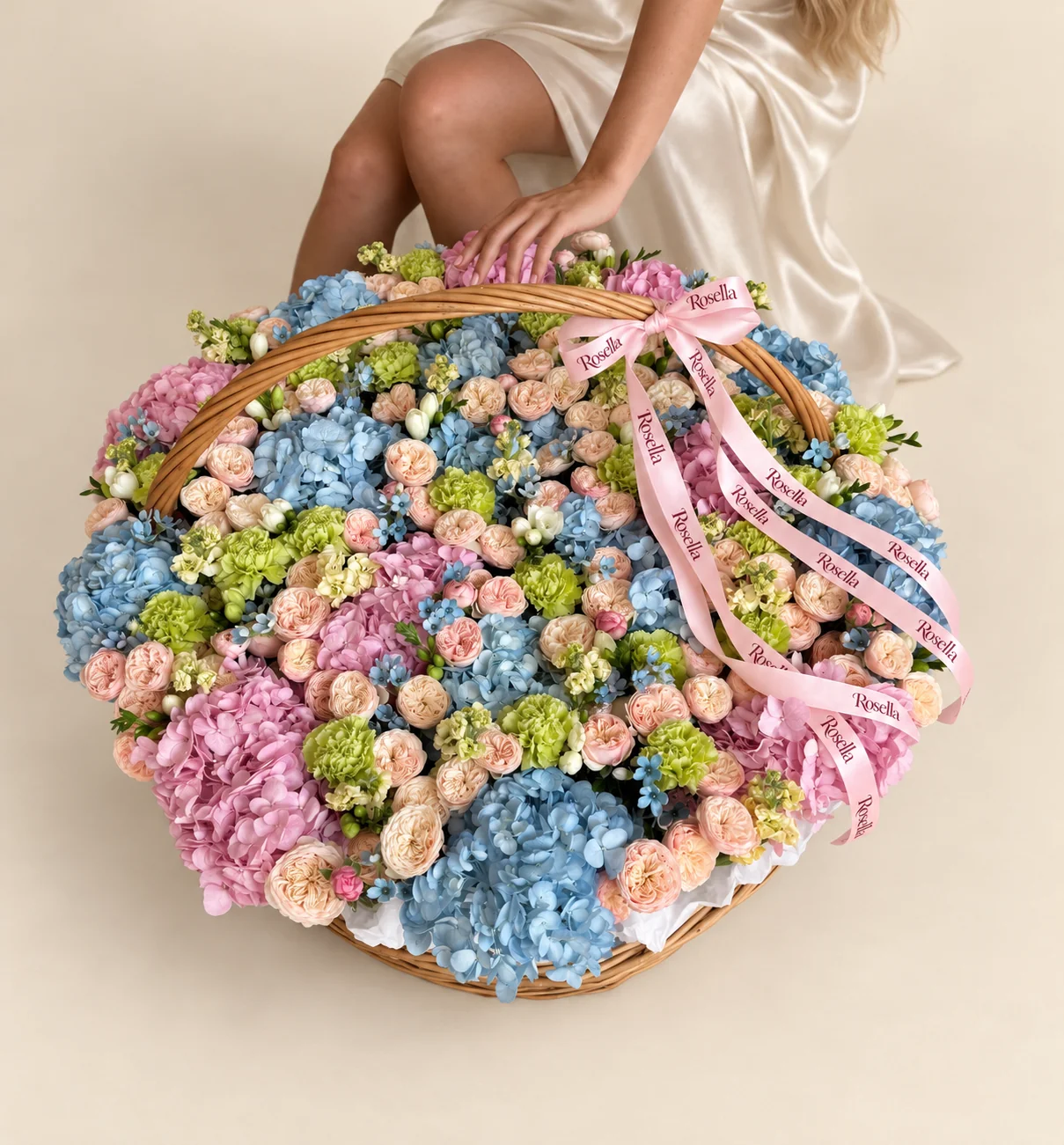 14 blue hydrangeas, 110 spray roses, 10 pink hydrangeas, 28 carnations, 7 stocks, 75 tweedia blooms & 8 freesias in a basket
