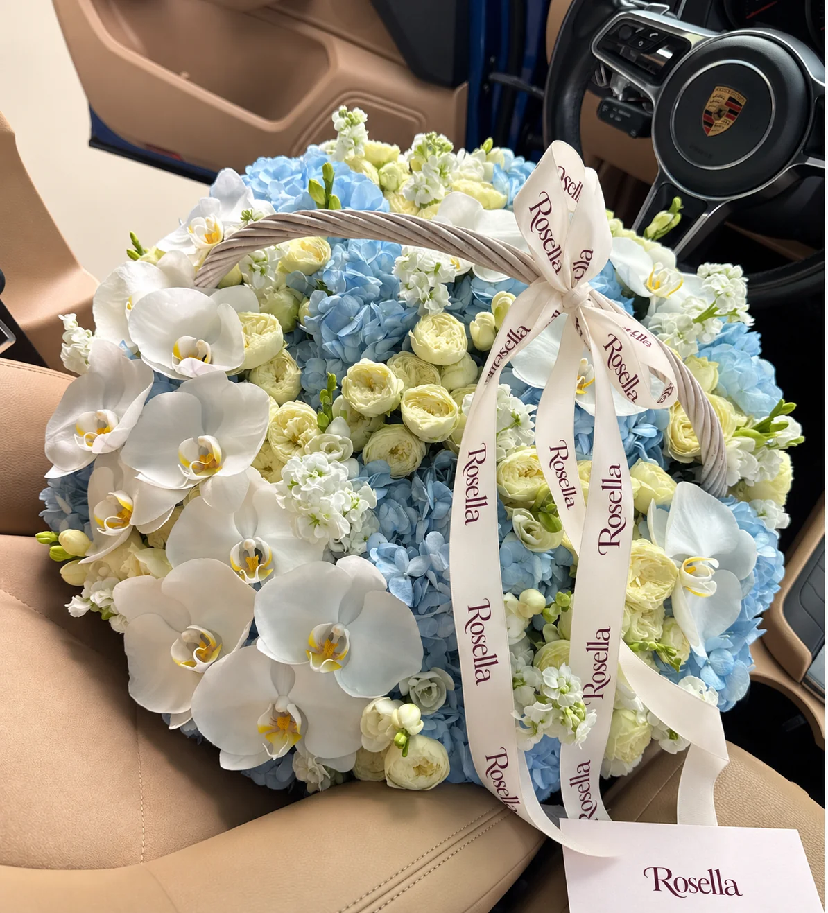 10 hydrangeas, 38 spray roses, 16 orchid blooms, 6 stocks & 4 freesias in a basket