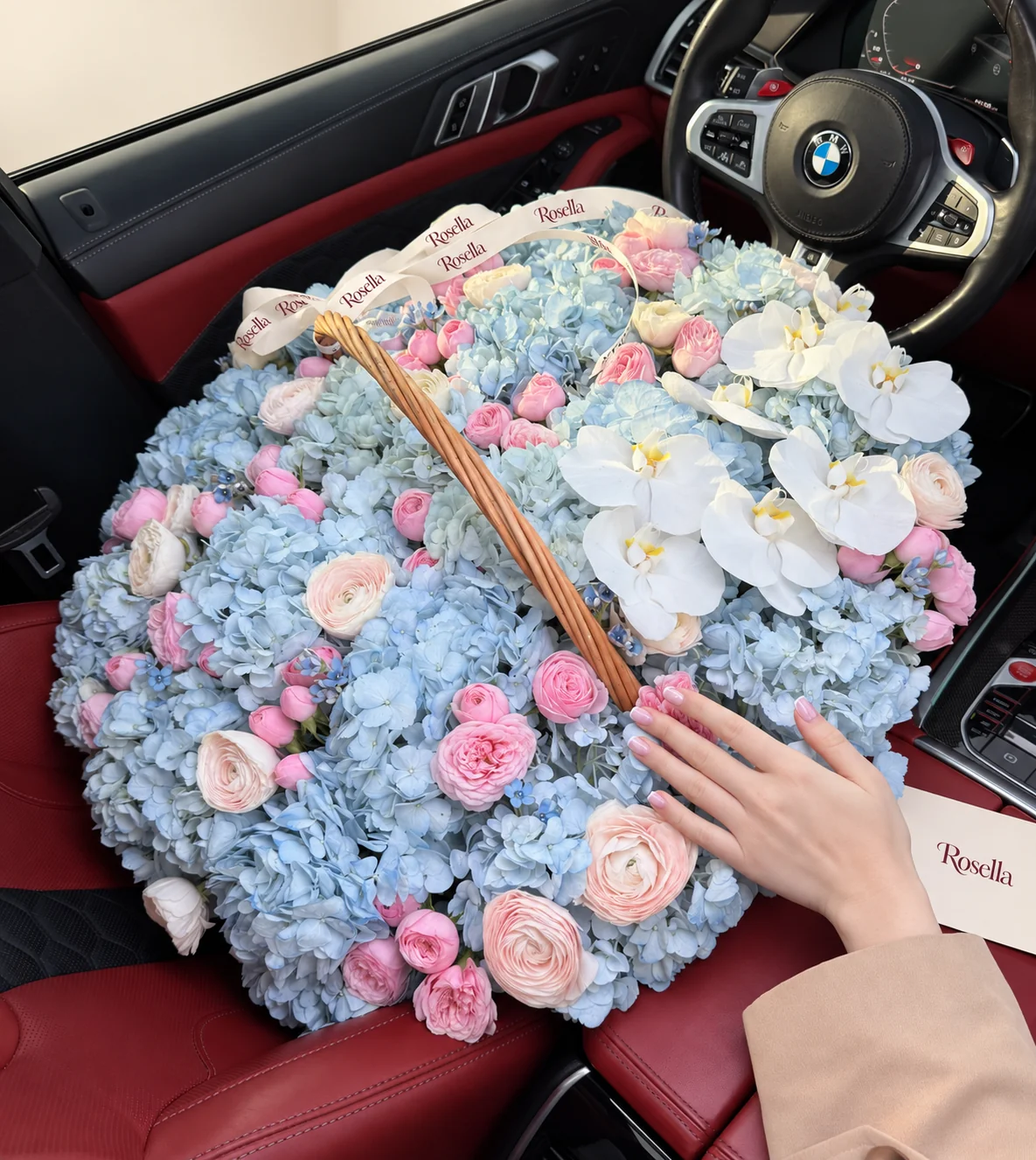 22 hydrangeas, 58 spray roses, 10 orchid blooms, 9 blush ranunculus, 9 ivory ranunculus & 22 tweedia blooms in a basket