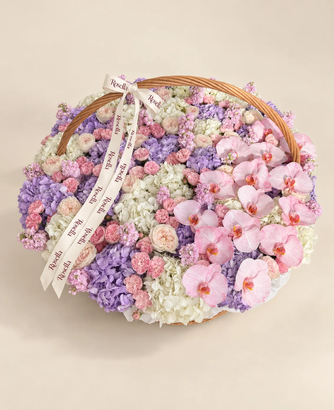 12 white hydrangeas, 11 lavender hydrangeas, 61 blush spray roses, 13 stocks, 17 orchid blooms & 22 cream spray roses in a basket