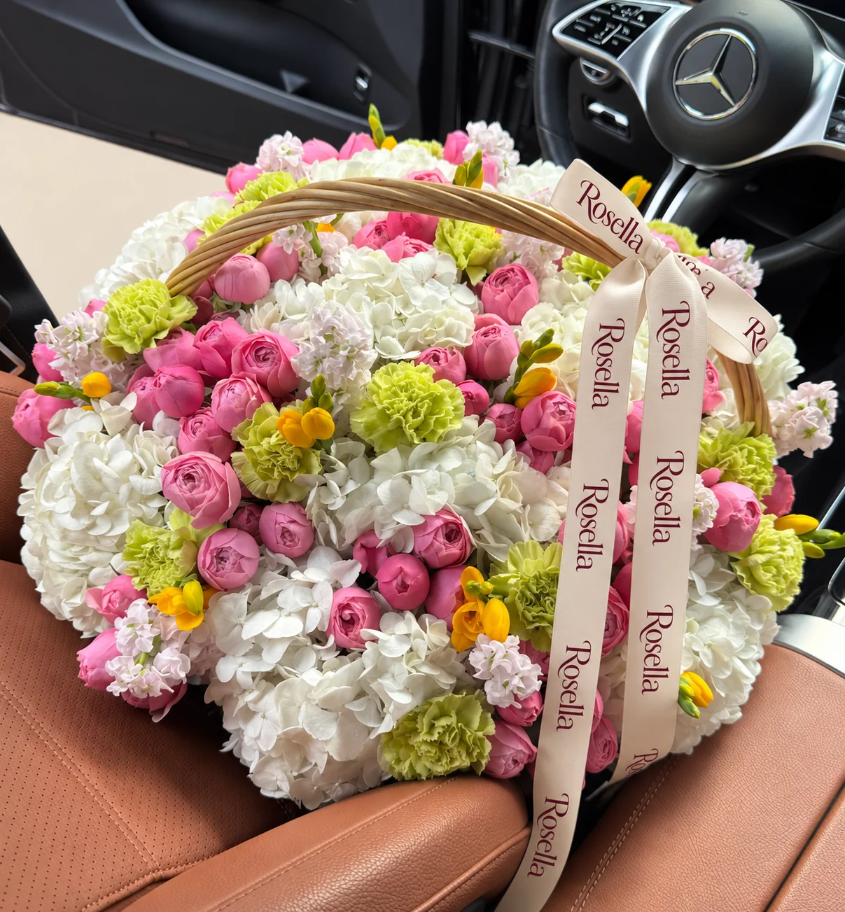 12 hydrangeas, 68 spray roses, 7 stocks, 16 carnations & 5 freesias in a basket