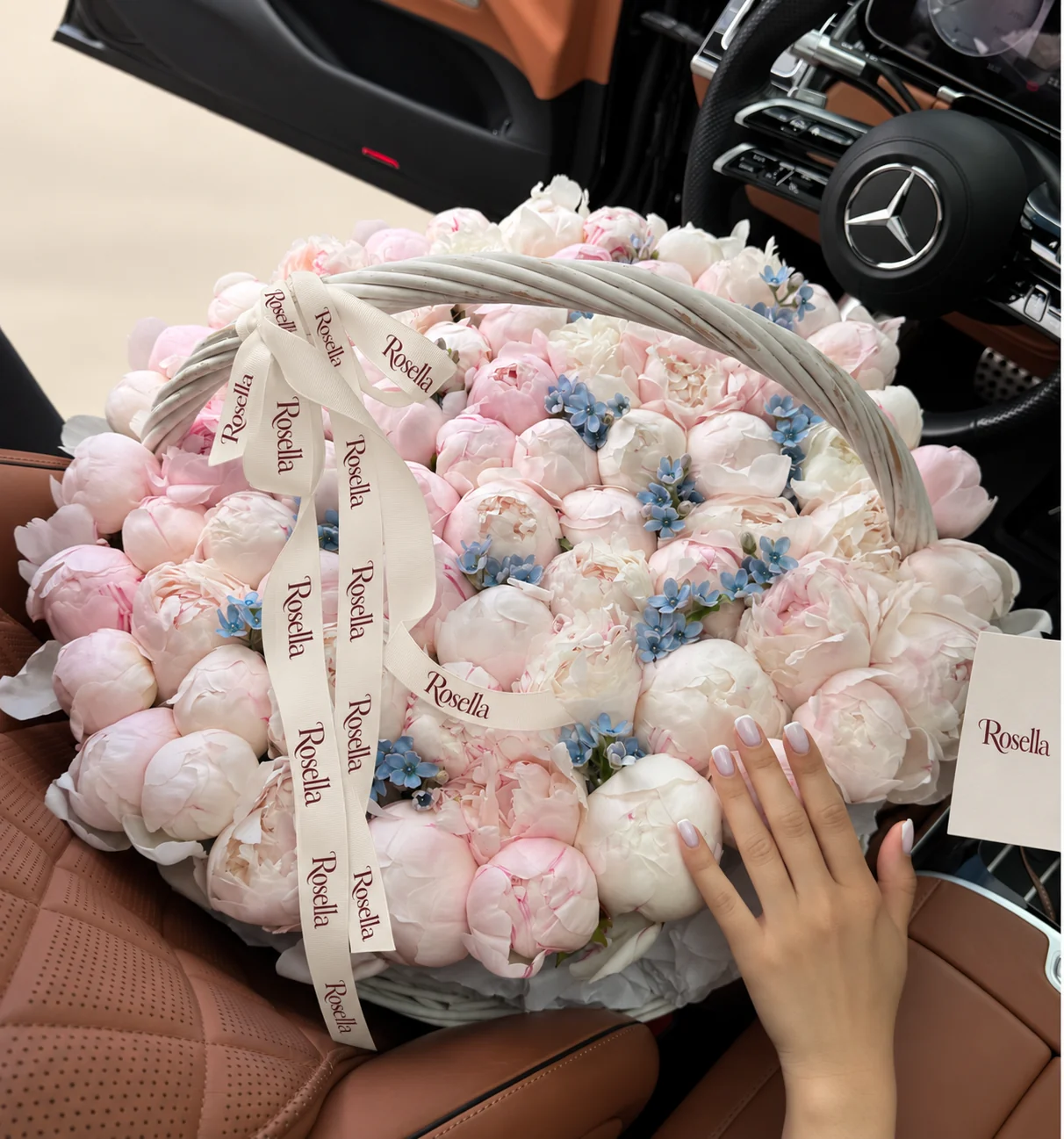 45 blush peonies, 34 ivory peonies & 70 tweedia blooms in a basket