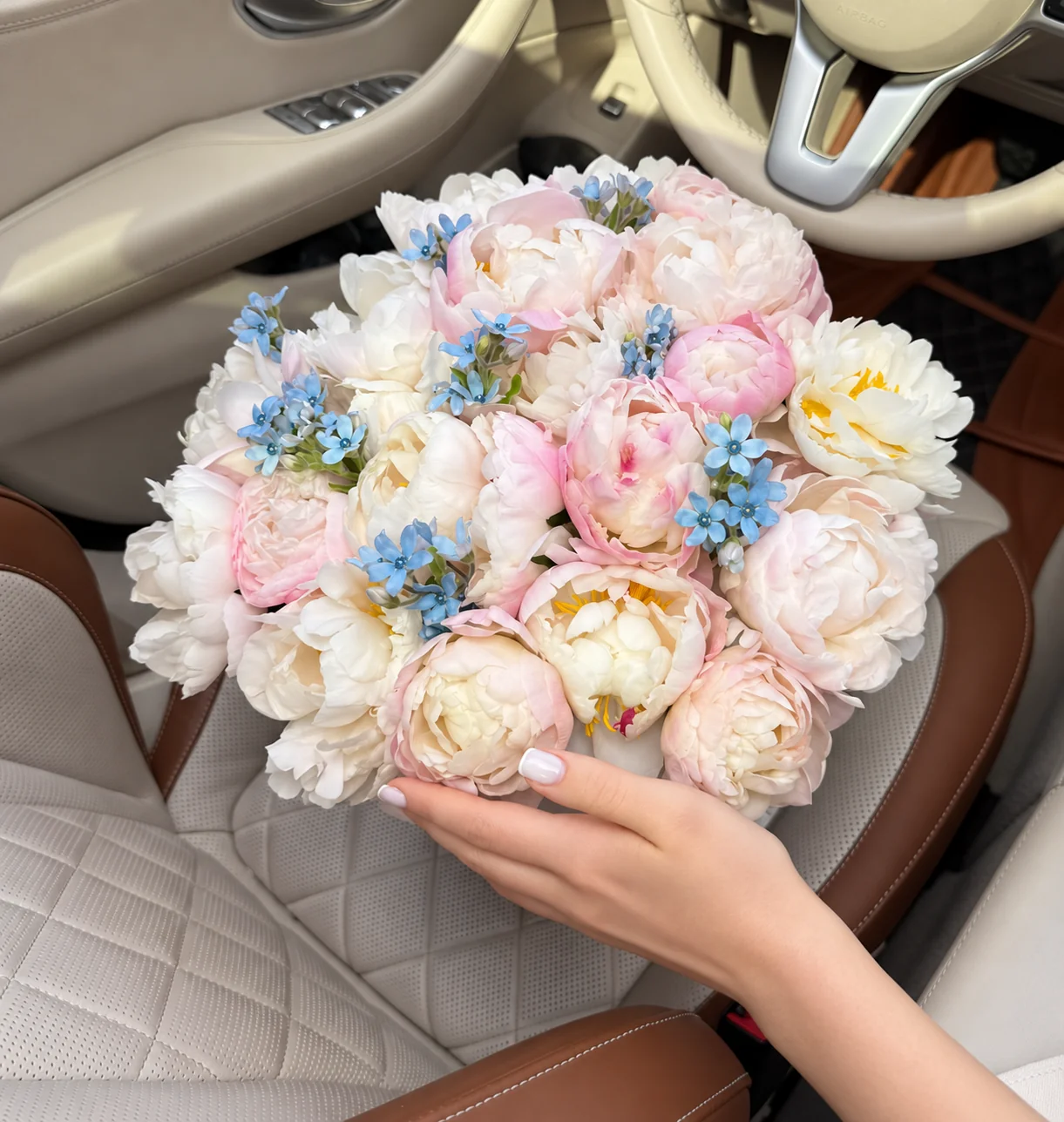 16 white peonies, 14 blush peonies & 48 tweedia blooms in a basket