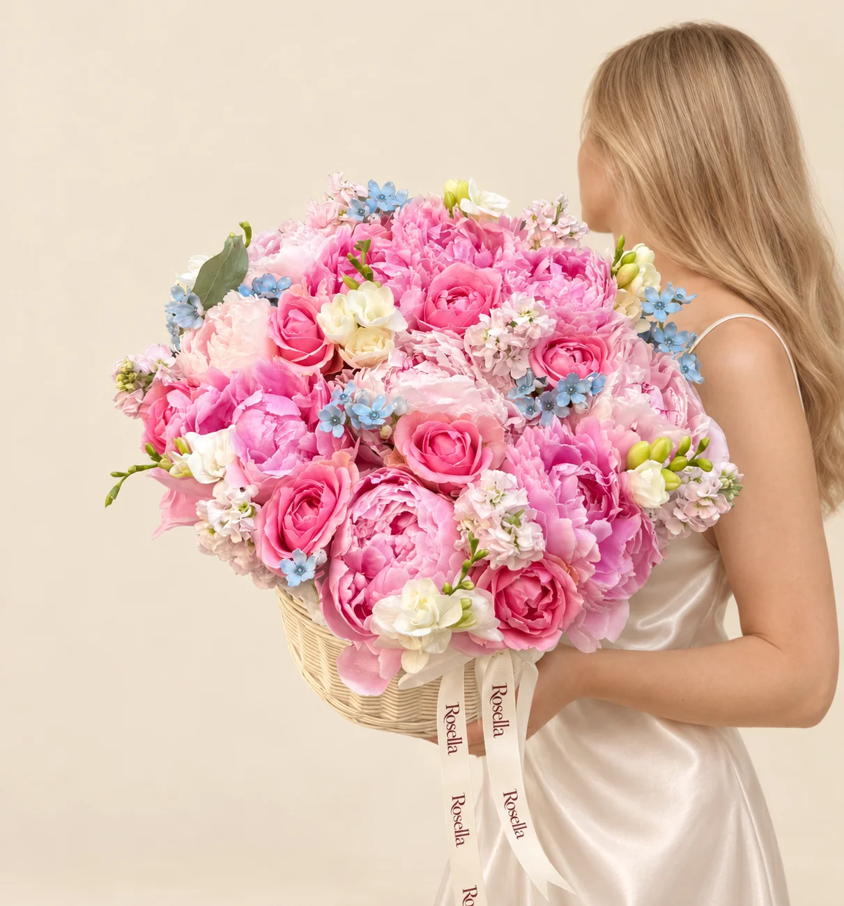 14 pink peonies, 5 blush peonies, 8 roses, 4 stocks, 29 tweedia blooms & 5 freesias in a basket