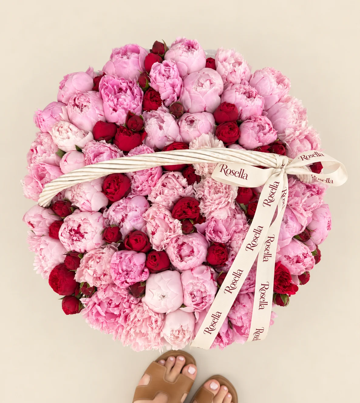 55 peonies, 48 spray roses, 2 ivory carnations & 2 pink carnations in a basket