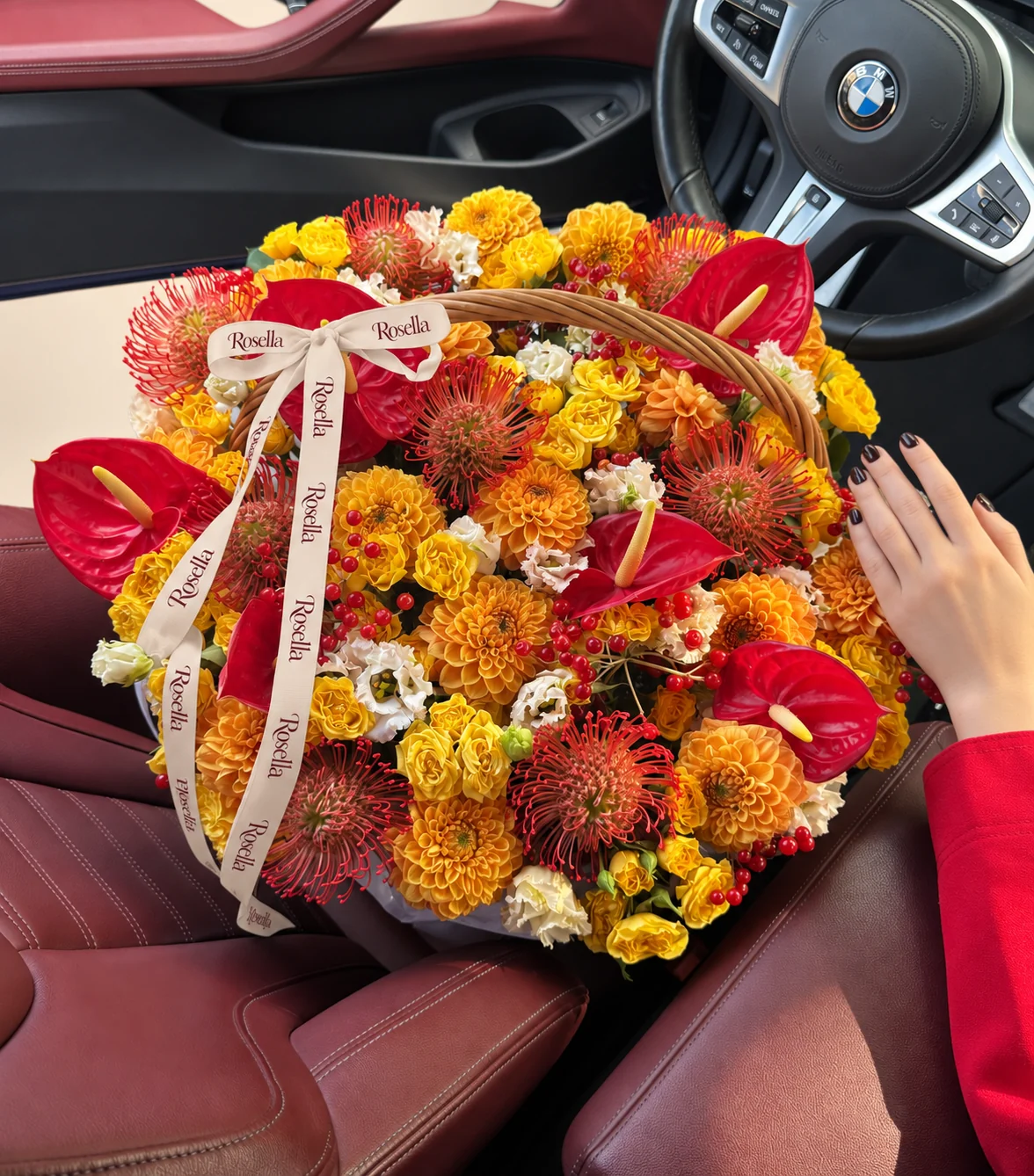 62 spray roses, 16 dahlias, 8 red-orange pincushion protea (leucospermum), 28 lisianthus blooms & 6 anthuriums in a basket