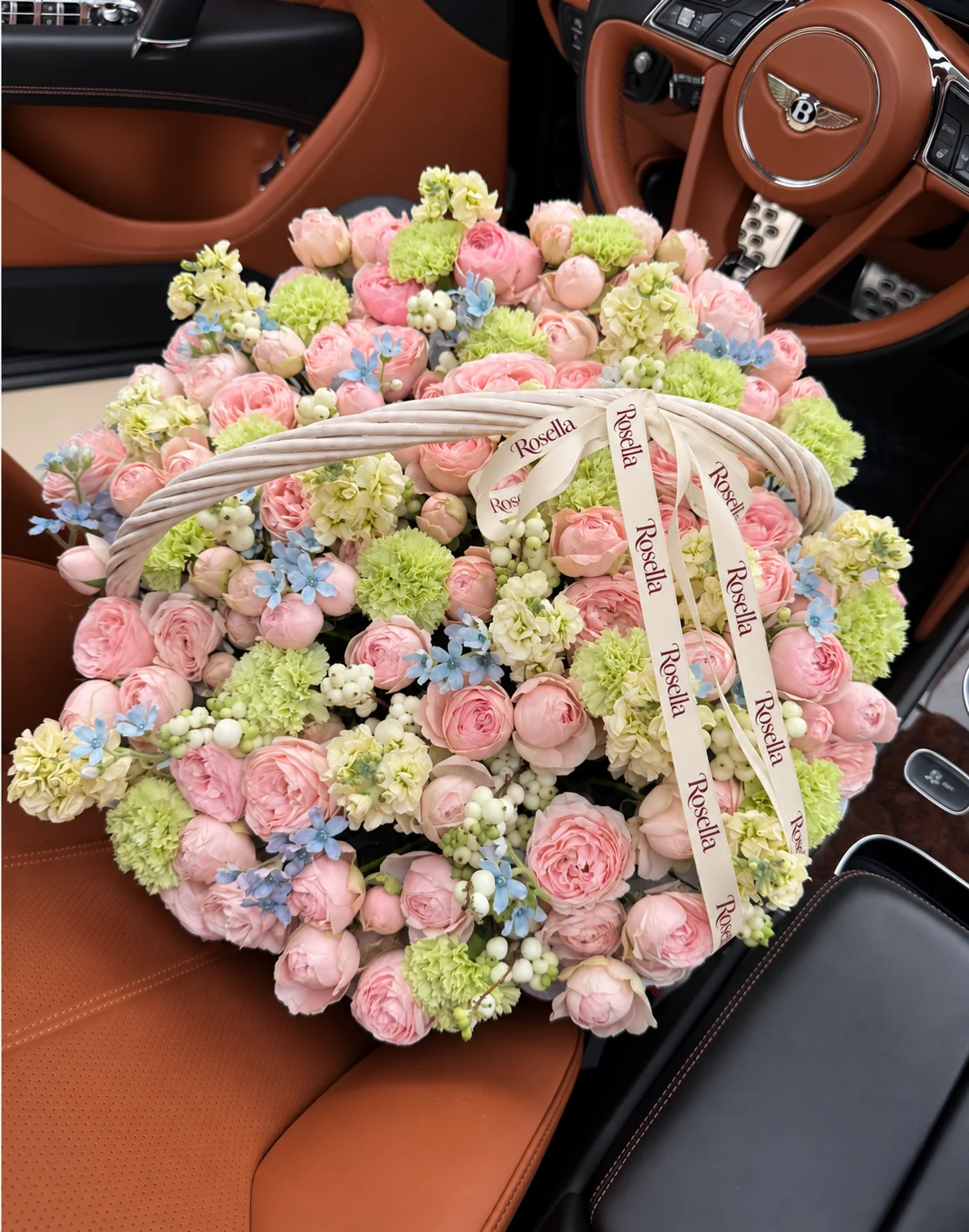 90 spray roses, 8 stocks, 19 carnations & 55 tweedia blooms in a basket