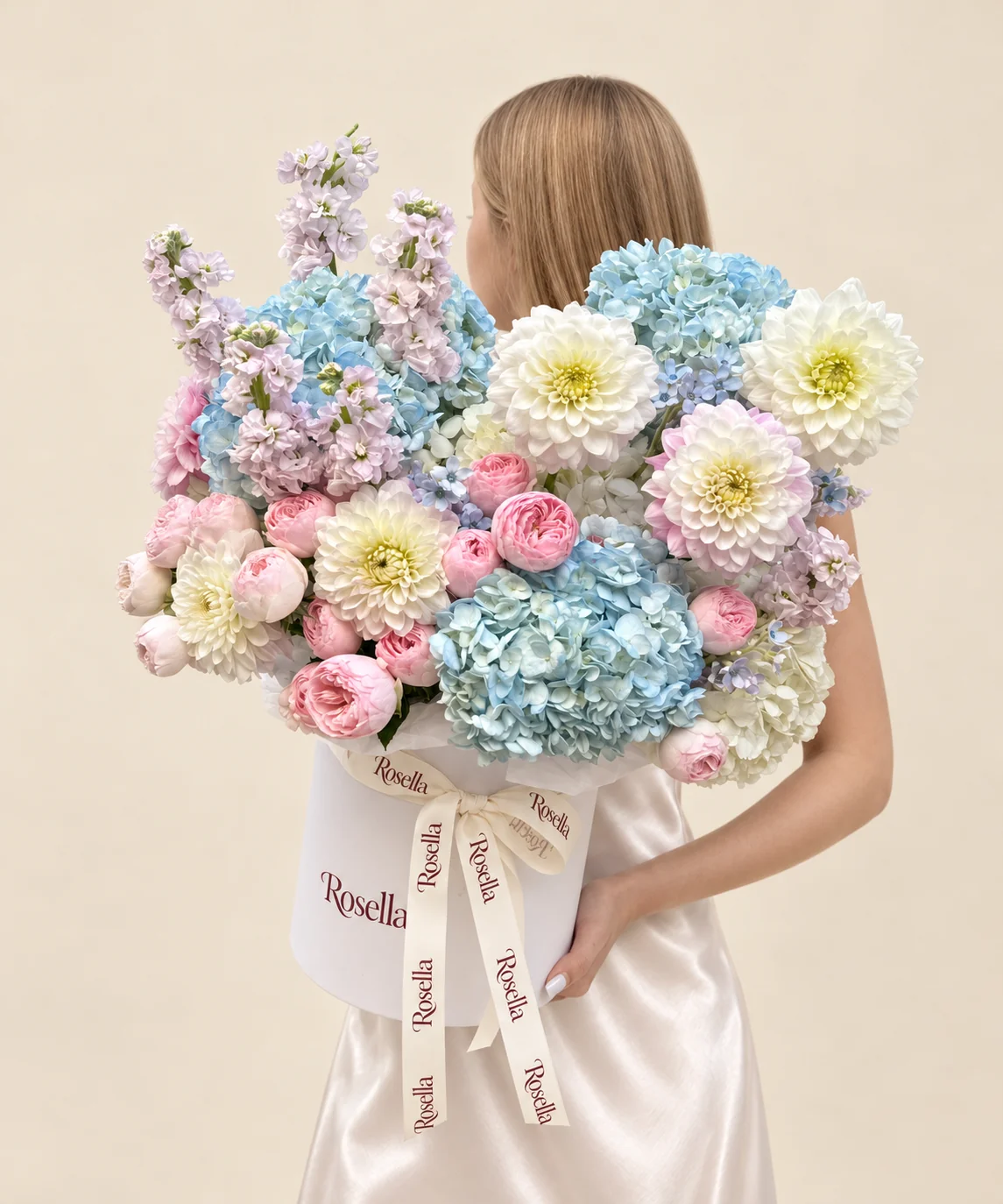17 garden roses, 5 blue hydrangeas, 6 stocks, 2 white hydrangeas, 4 white dahlias, 1 white dahlia & 1 pink dahlia in a round box
