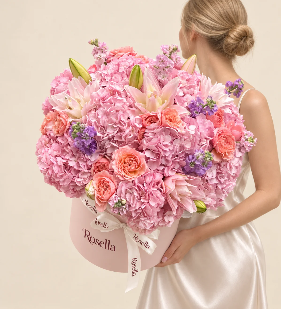 13 hydrangeas, 14 garden roses, 11 lily blooms, 3 pink stocks & 3 lavender stocks in a round box