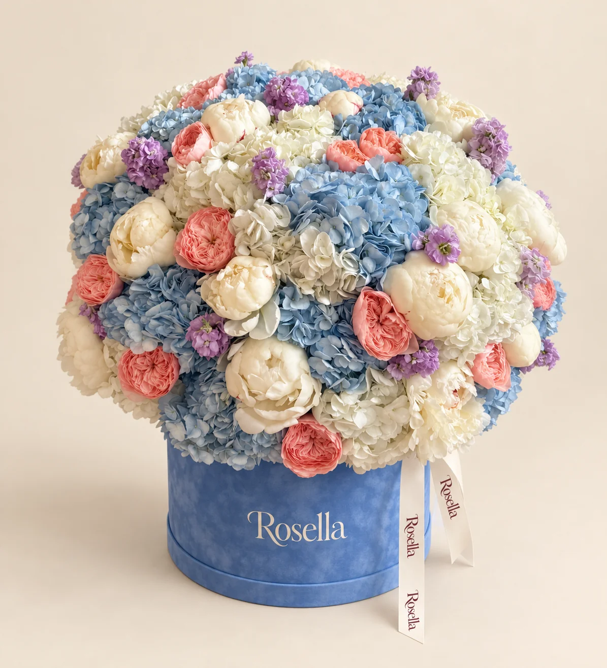 16 blue hydrangeas, 11 cream hydrangeas, 18 peonies, 18 garden roses & 7 stocks in a round box