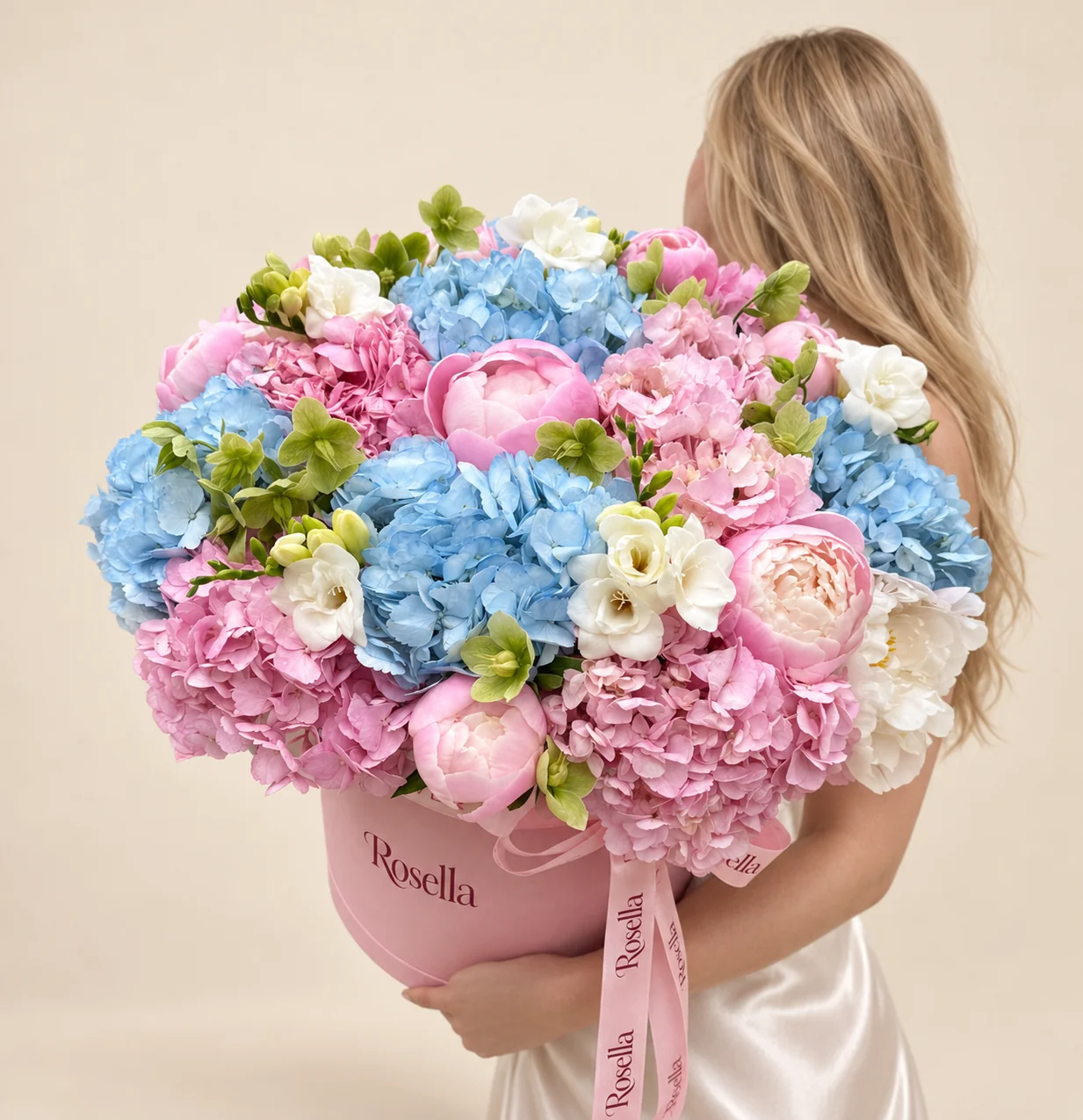 6 pink hydrangeas, 5 blue hydrangeas, 10 pink peonies, 18 green hellebore, 1 white peony & 3 freesias in a round box