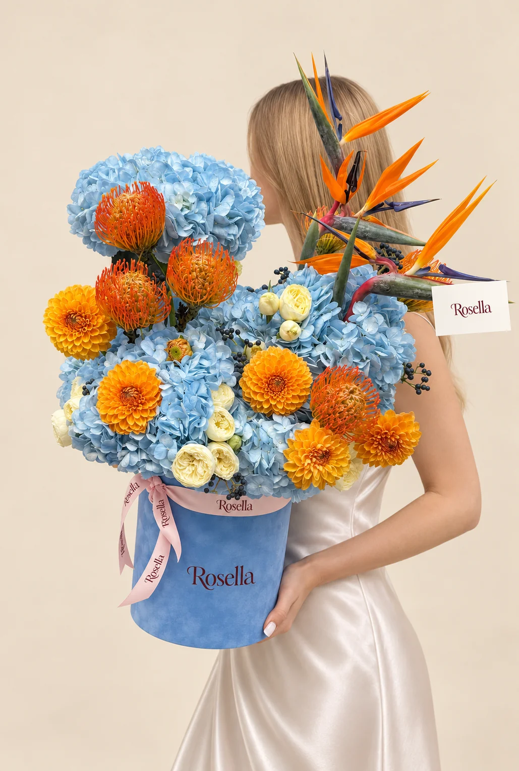 7 hydrangeas, 6 orange leucospermum (pincushion protea), 6 dahlias, 4 orange and blue strelitzia (bird of paradise) & 15 spray roses in a round box