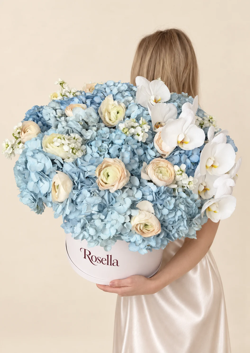 12 hydrangeas, 13 ranunculus, 4 stocks & 8 orchid blooms in a round box