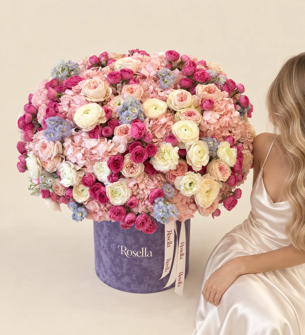 16 hydrangeas, 105 spray roses, 22 garden roses, 19 ranunculus & 4 delphiniums in a round box