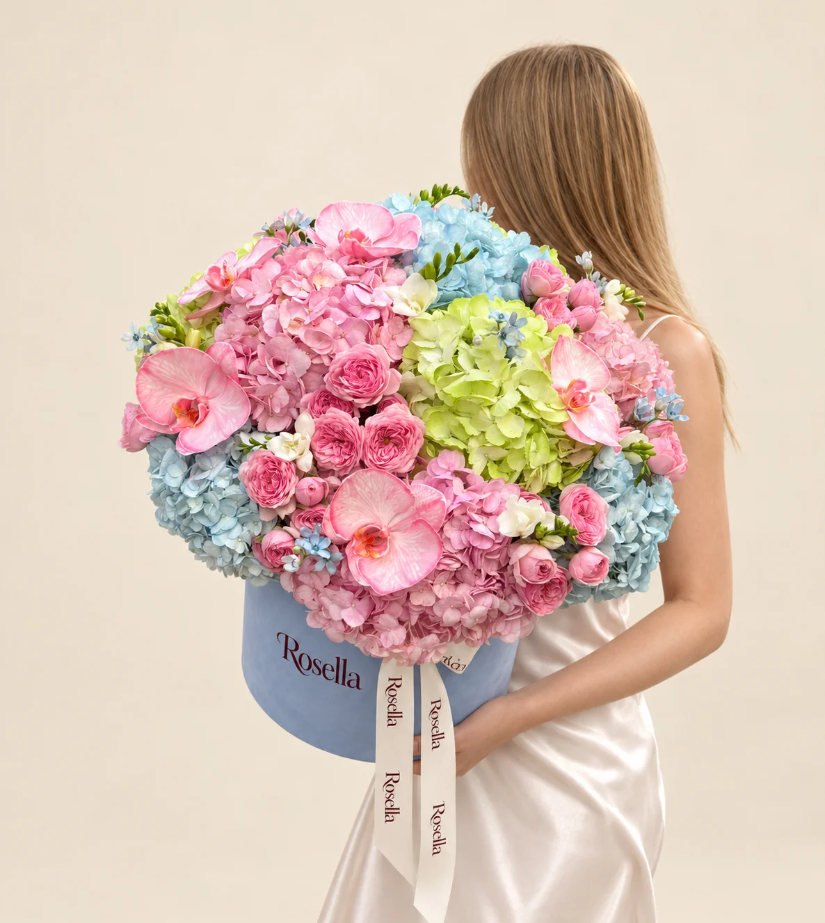 5 pink hydrangeas, 4 blue hydrangeas, 26 spray roses, 2 green hydrangeas, 5 orchid blooms, 20 tweedia blooms & 3 freesias in a round box