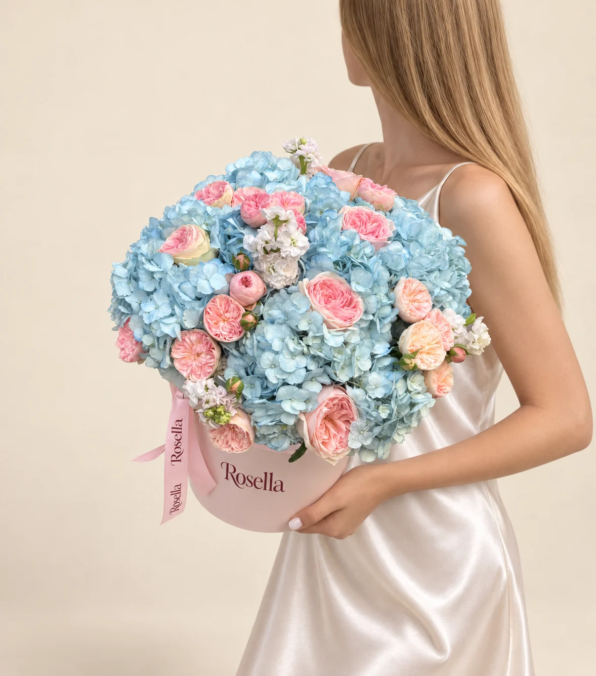 11 hydrangeas, 21 pink spray roses, 3 stocks & 9 peach spray roses in a round box