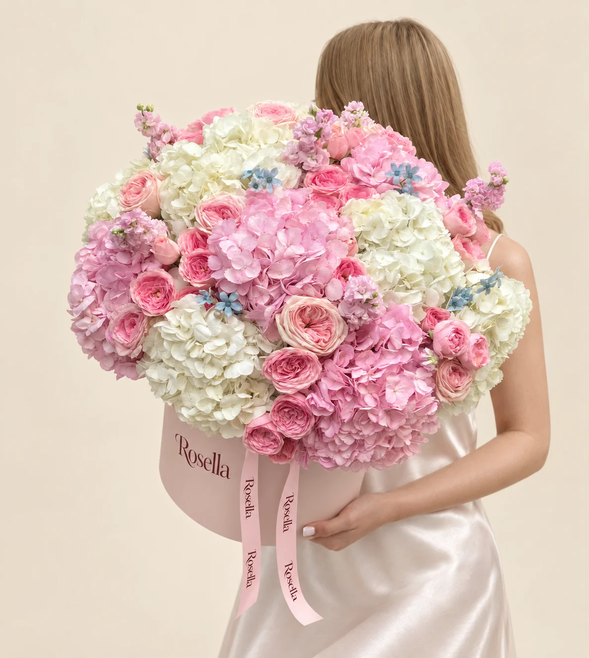 7 ivory hydrangeas, 5 pink hydrangeas, 36 spray roses, 4 stocks & 14 tweedia blooms in a round box