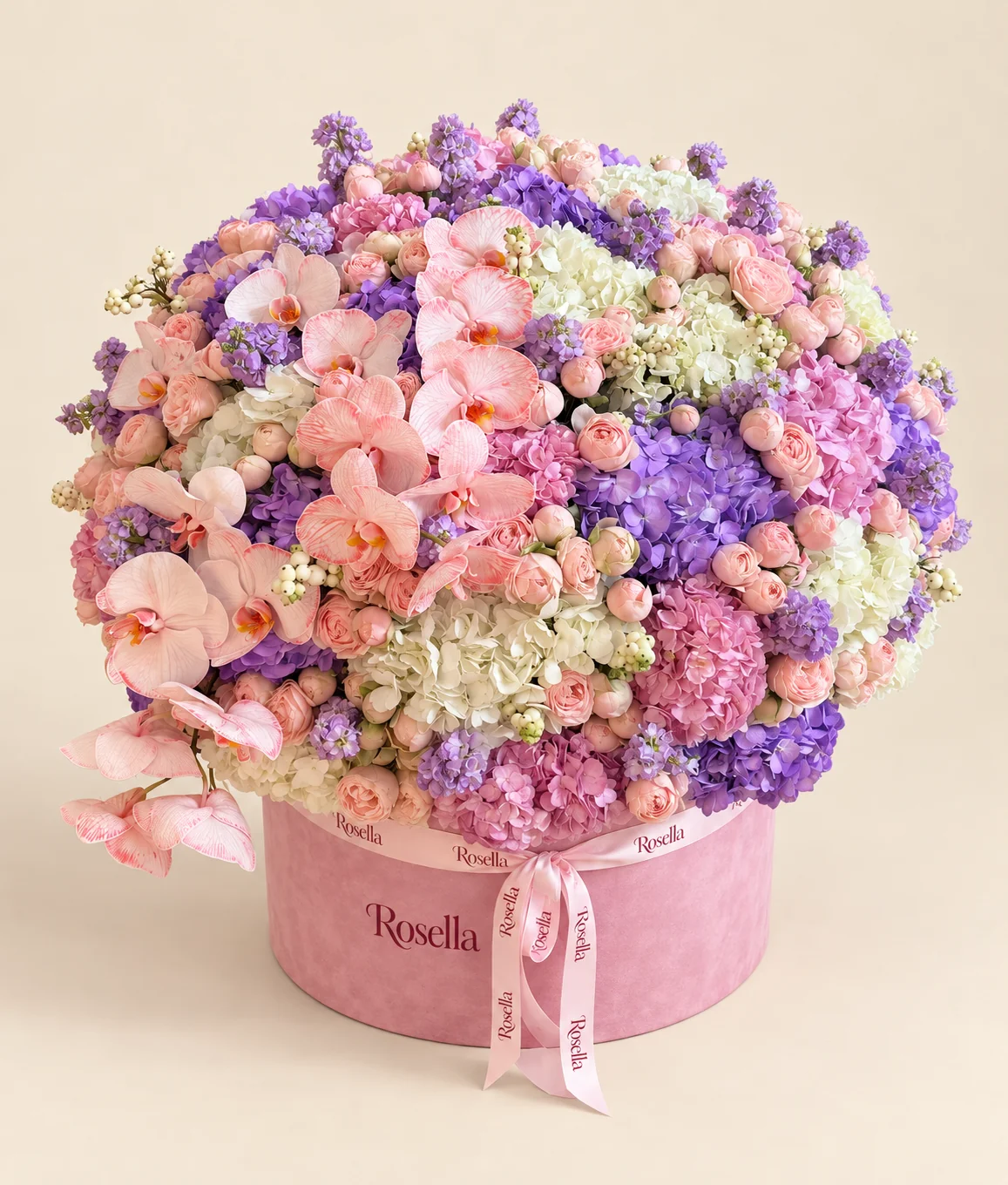 12 white hydrangeas, 12 purple hydrangeas, 100 spray roses, 10 pink hydrangeas, 11 stocks & 18 orchid blooms in a round box