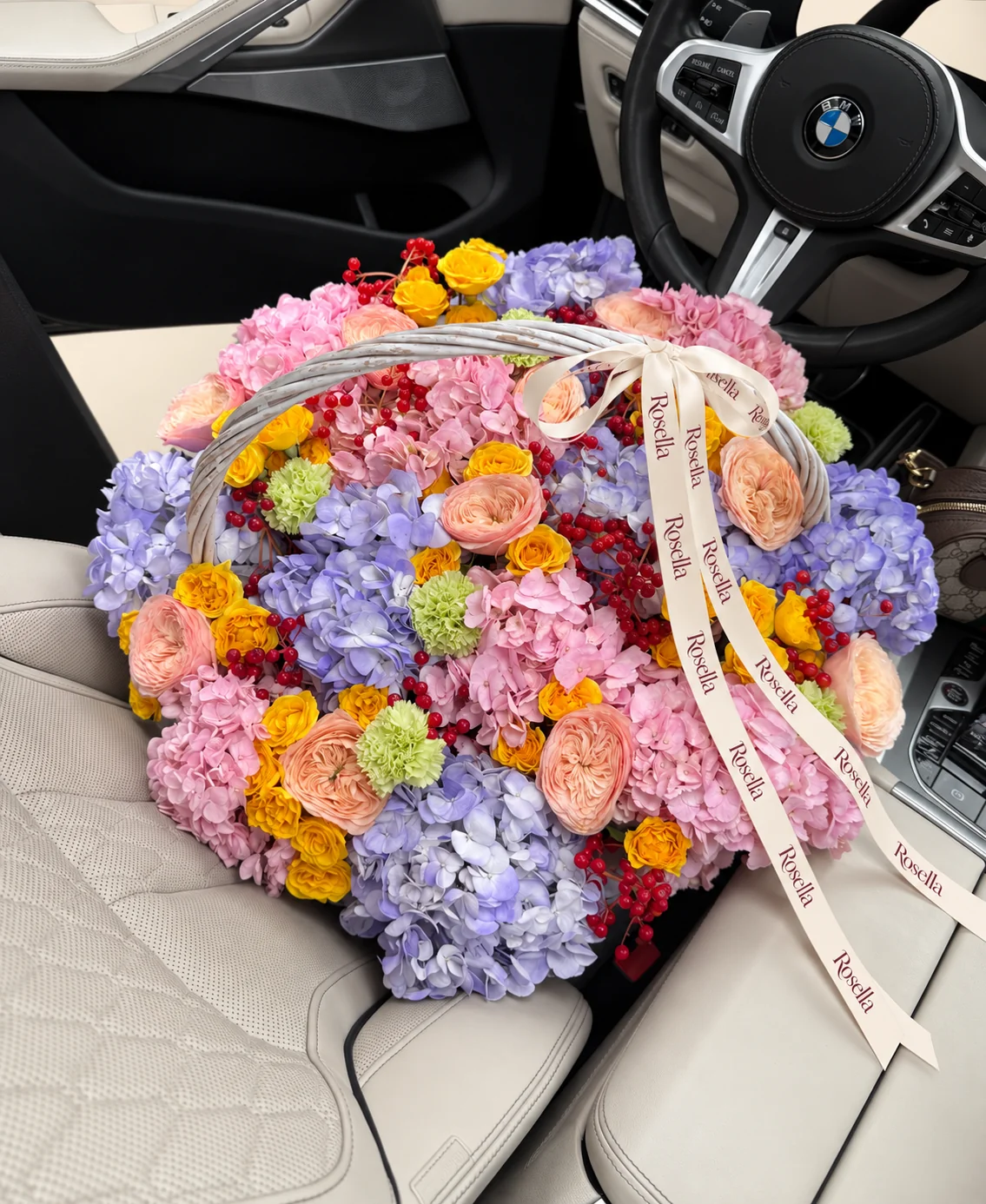 9 lavender hydrangeas, 9 pink hydrangeas, 12 garden roses, 38 spray roses & 6 carnations in a basket