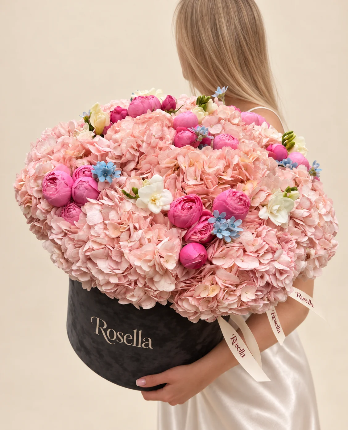 13 hydrangeas, 21 spray roses, 23 tweedia blooms & 4 freesias in a round box