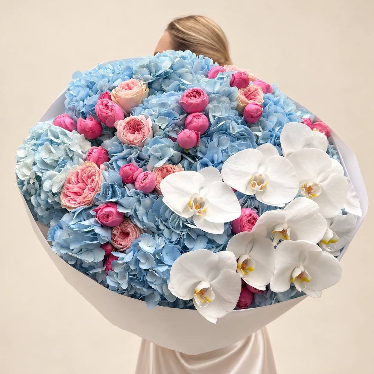 14 hydrangeas, 8 garden roses, 26 spray roses & 9 orchid blooms in a hand-tied bouquet
