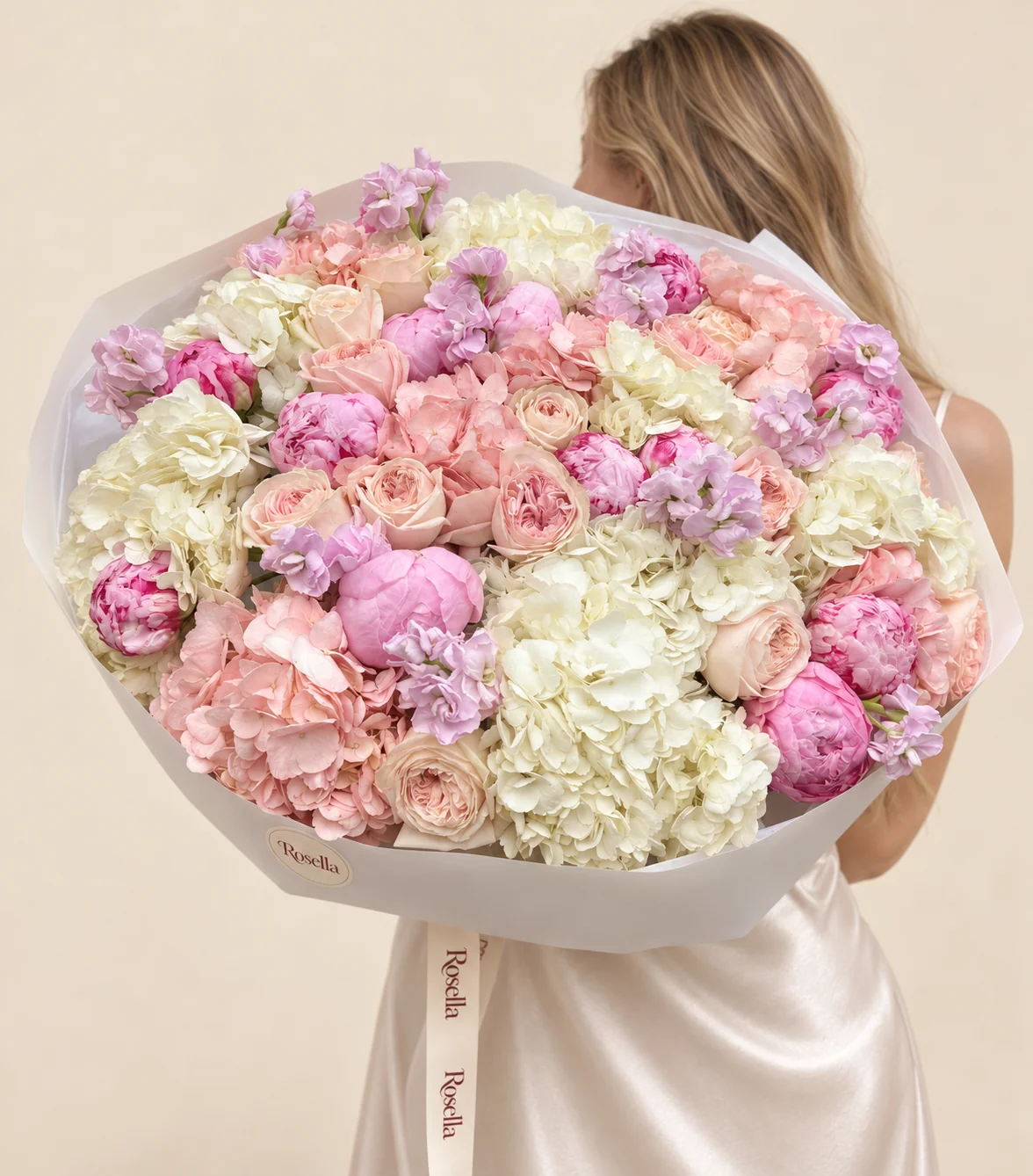 8 white hydrangeas, 15 peonies, 15 garden roses, 6 peach hydrangeas & 4 stocks in a hand-tied bouquet