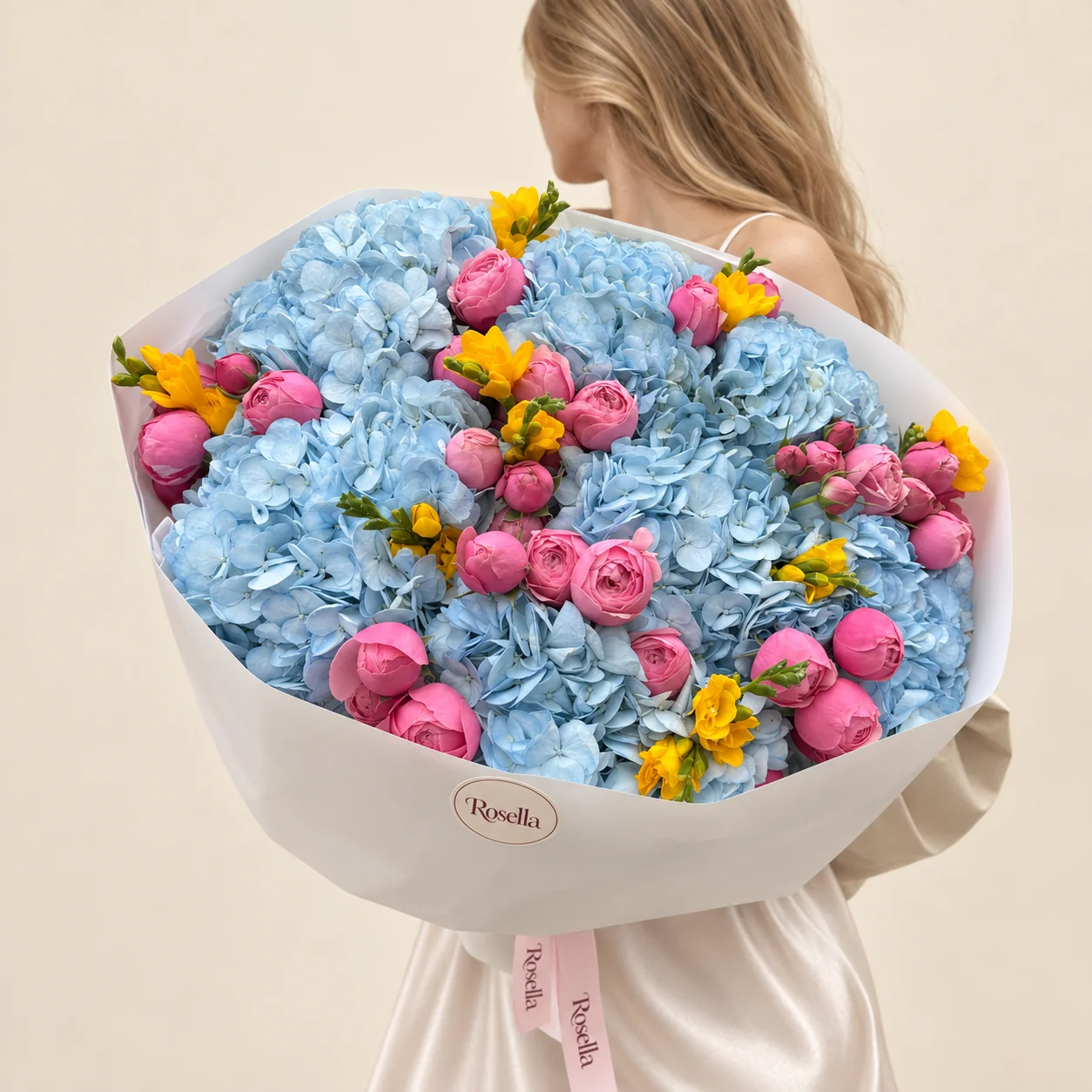 11 hydrangeas, 38 spray roses & 7 freesias in a hand-tied bouquet