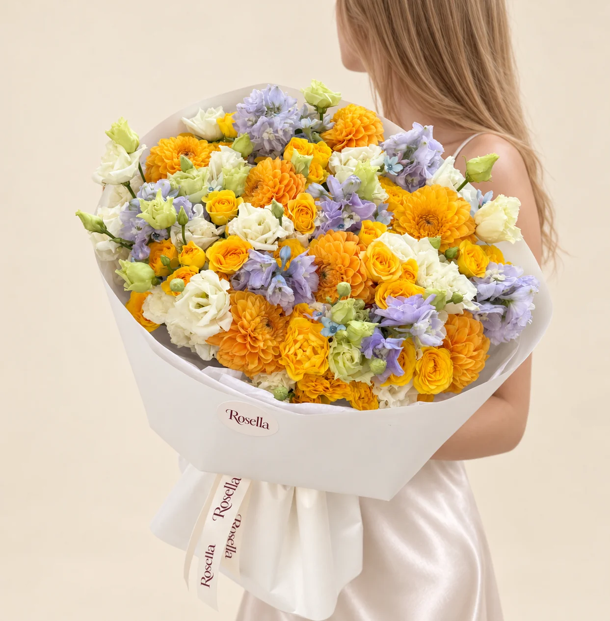 12 dahlias, 26 spray roses, 4 delphiniums, 27 lisianthus blooms & 9 tweedia blooms in a hand-tied bouquet