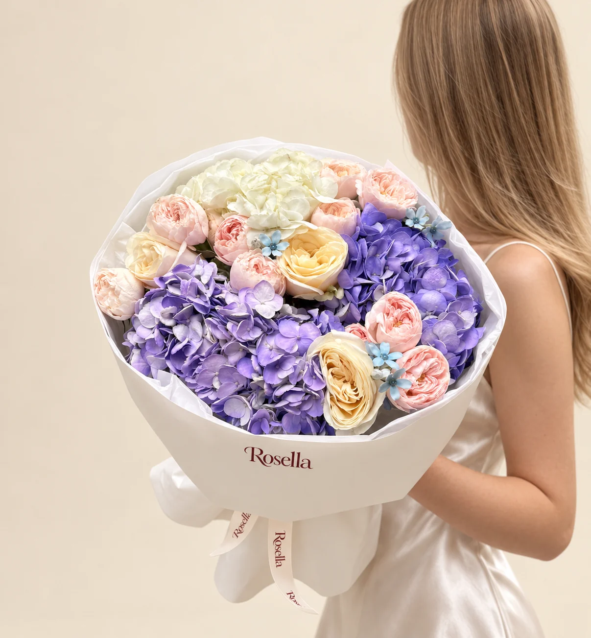 12 blush garden roses, 3 lavender hydrangeas, 2 white hydrangeas, 3 cream garden roses & 6 tweedia blooms in a hand-tied bouquet