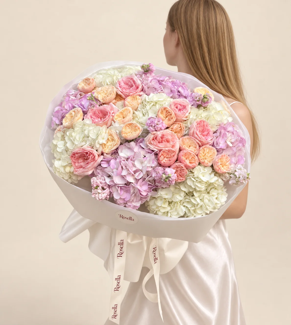 23 cream garden roses, 8 white hydrangeas, 6 lilac hydrangeas, 7 blush garden roses & 4 stocks in a hand-tied bouquet